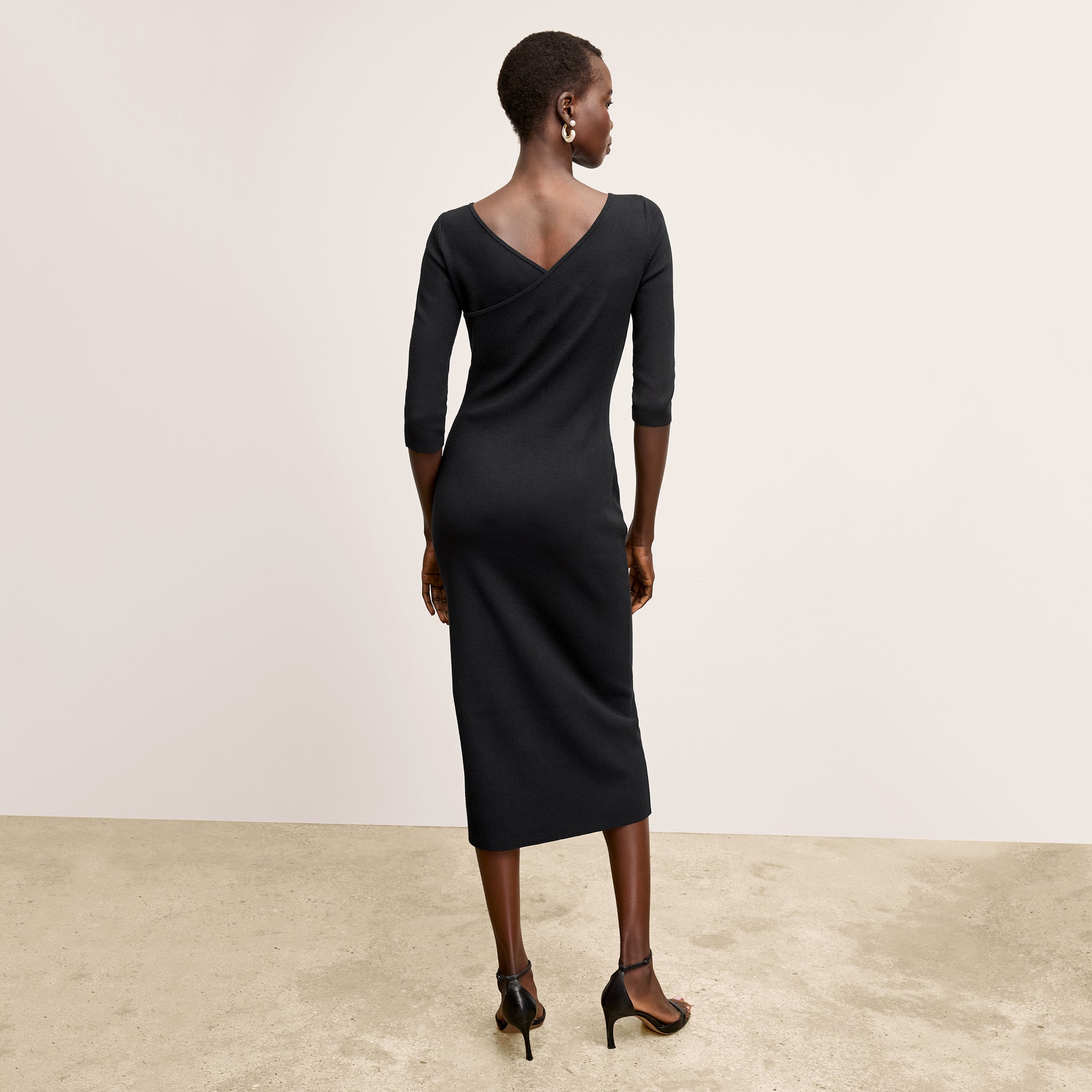 Back image of a woman wearing the Zana Dress in Black