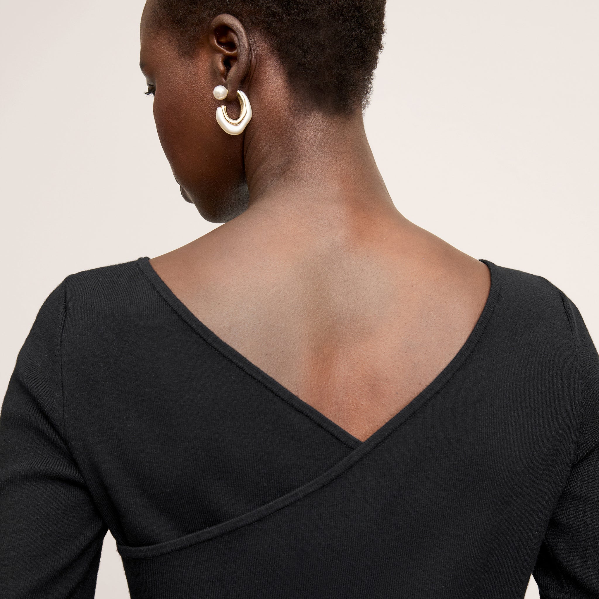 Back image of a woman wearing the Zana Dress in Black