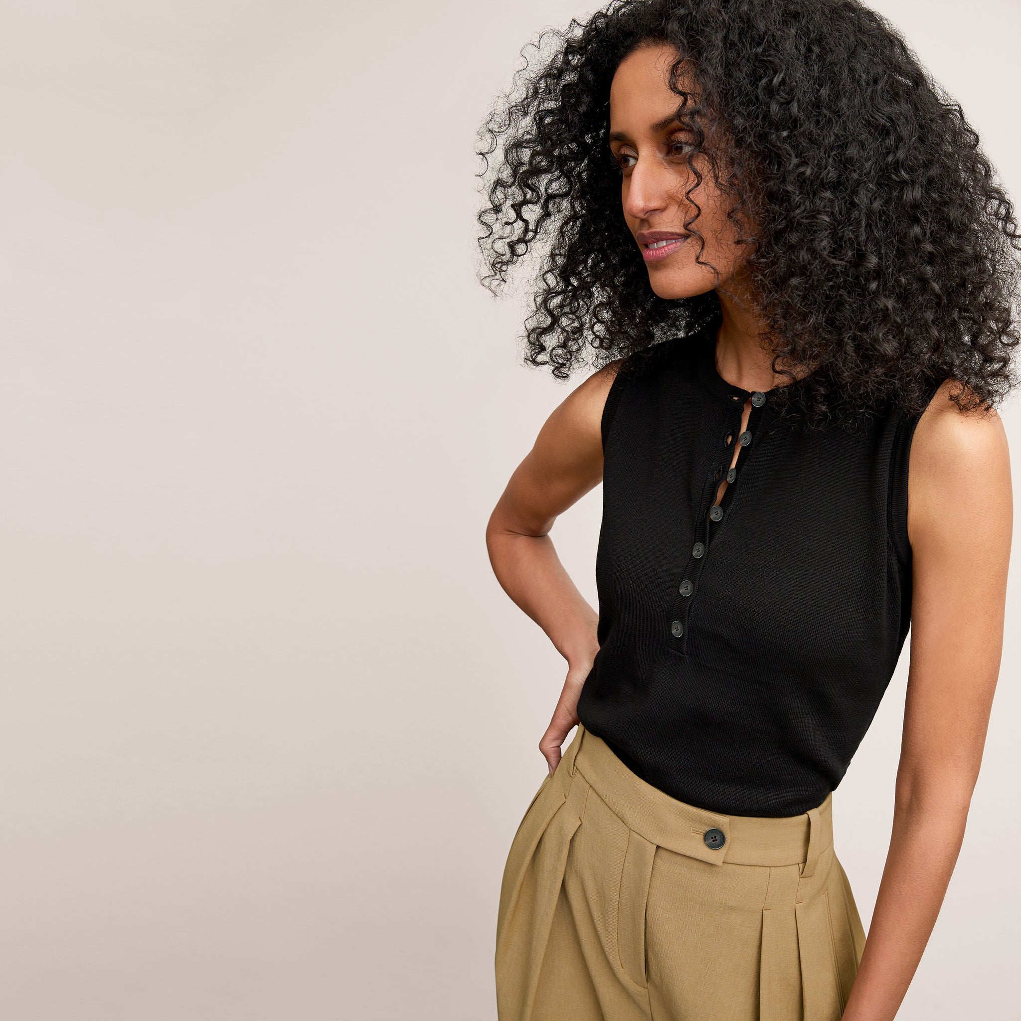 image of a woman wearing the crimmins top in black  