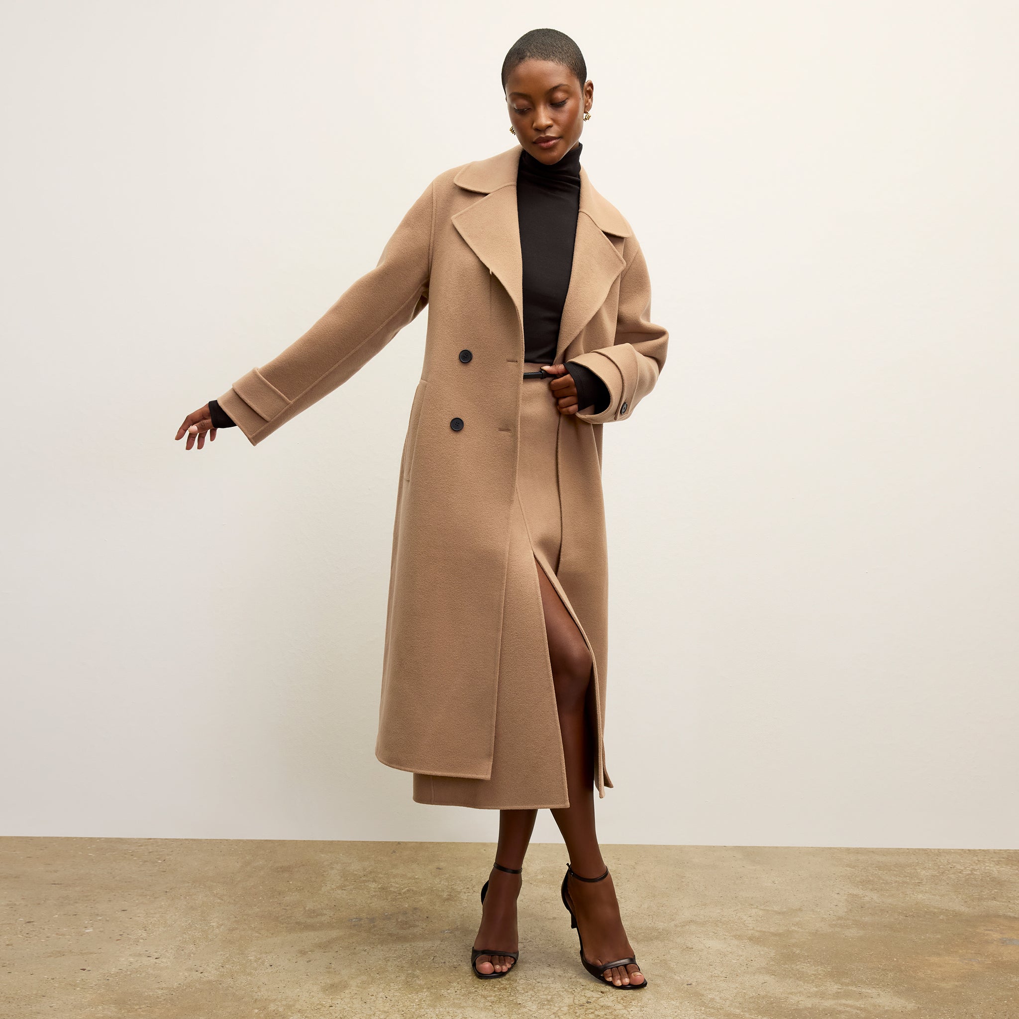 front image of a woman wearing the viola coat in camel 