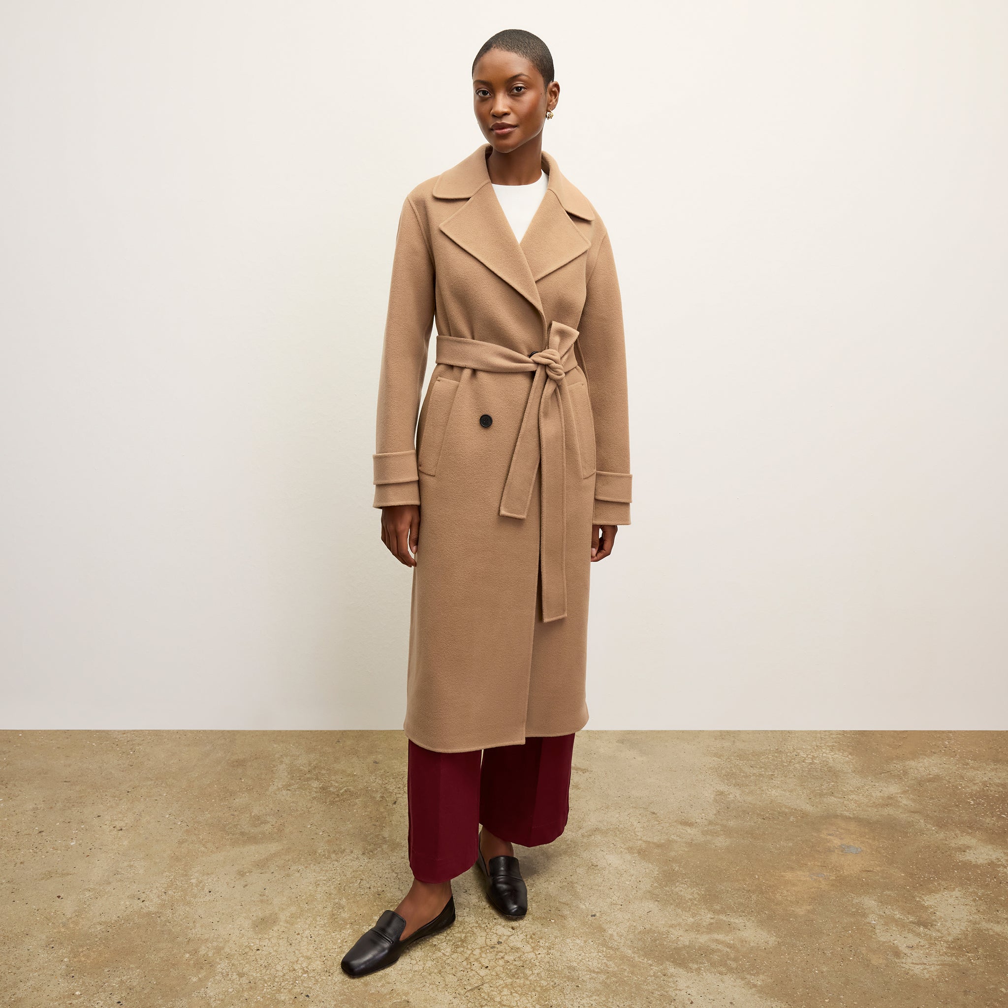 front image of a woman wearing the viola coat in camel 