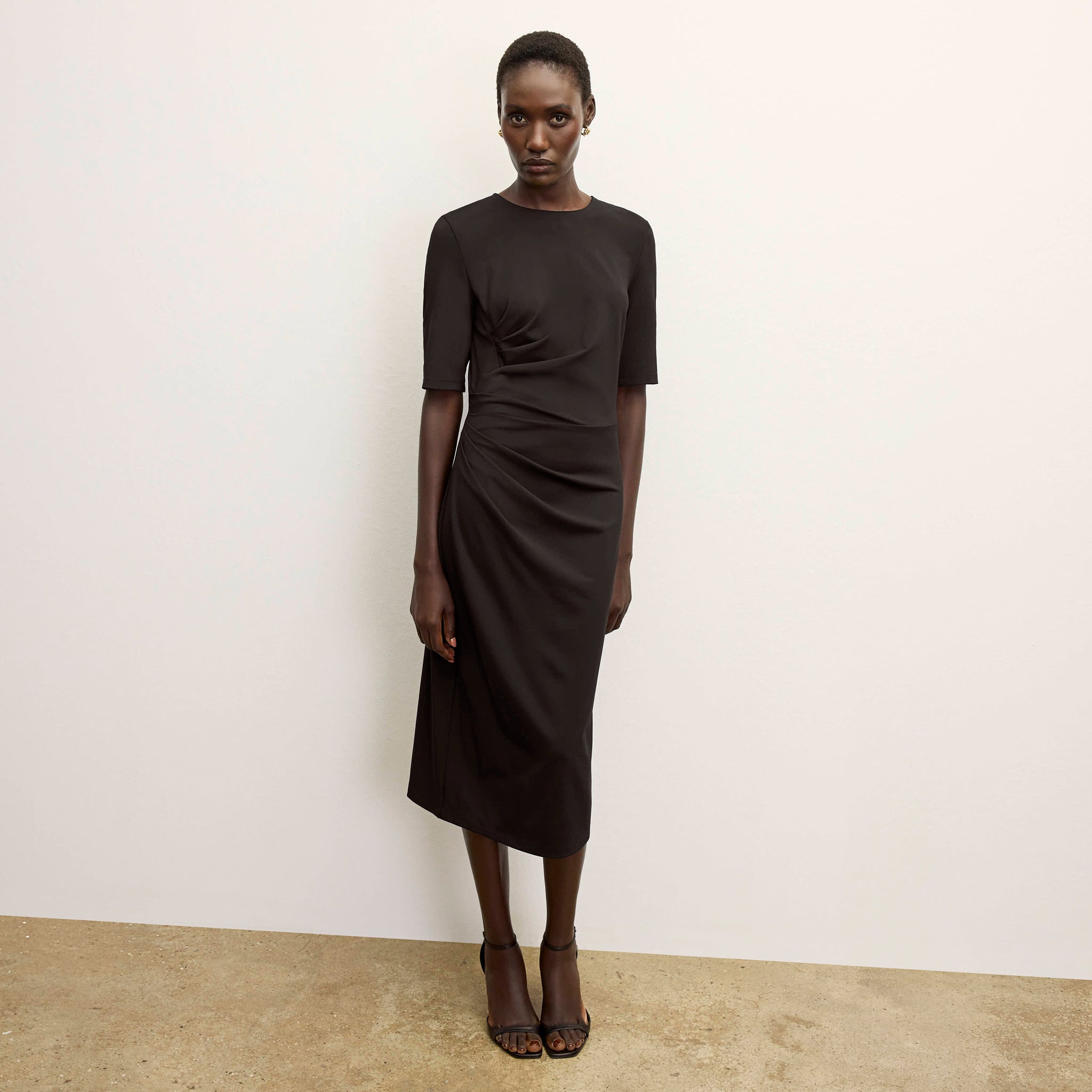 front image of a woman wearing the ciela dress in black  