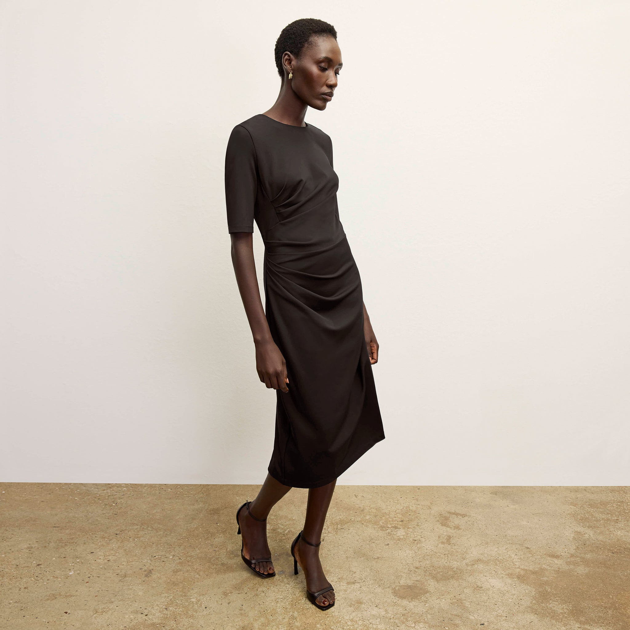 front image of a woman wearing the ciela dress in black