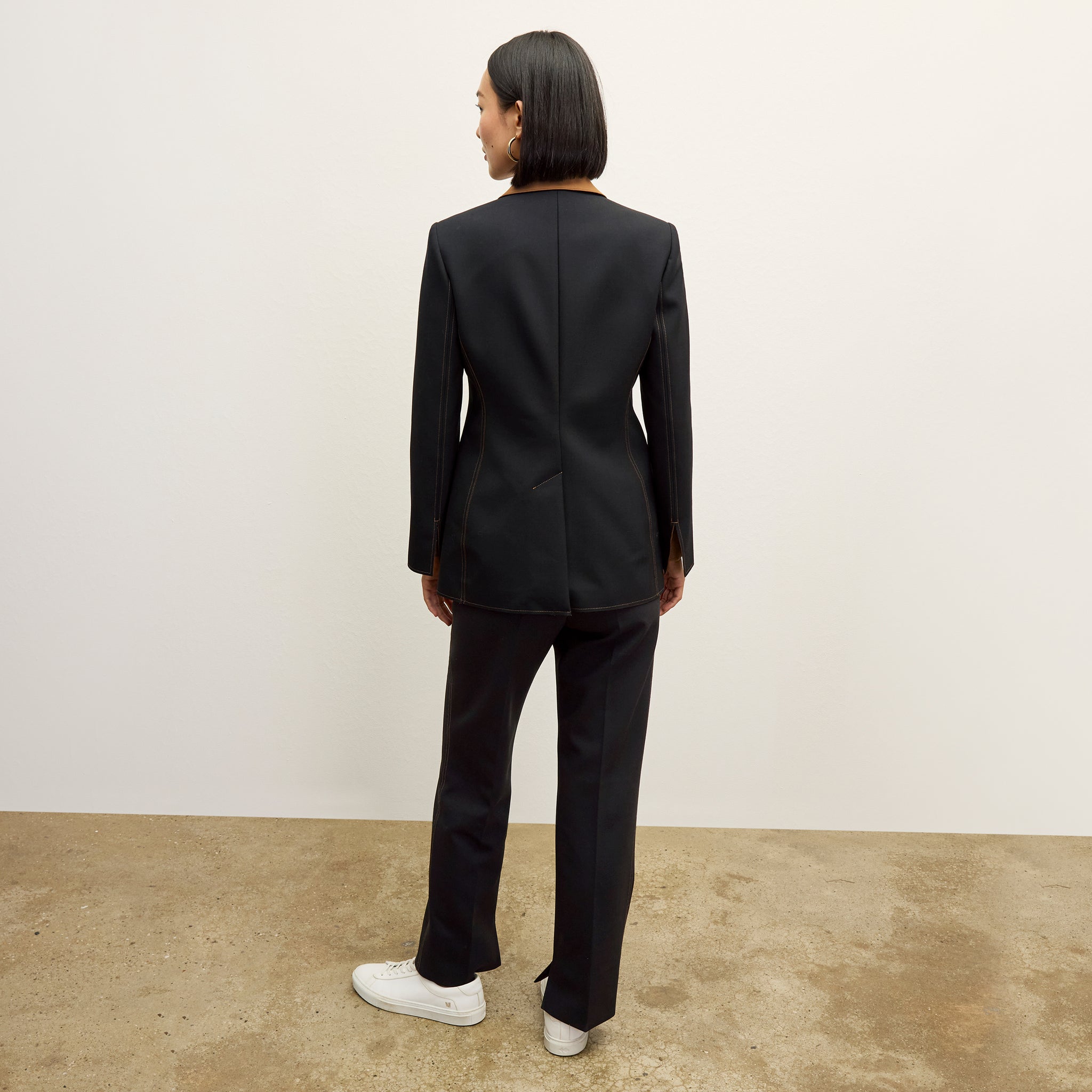 back image of a woman wearing the harley jacket in black/light saddle 