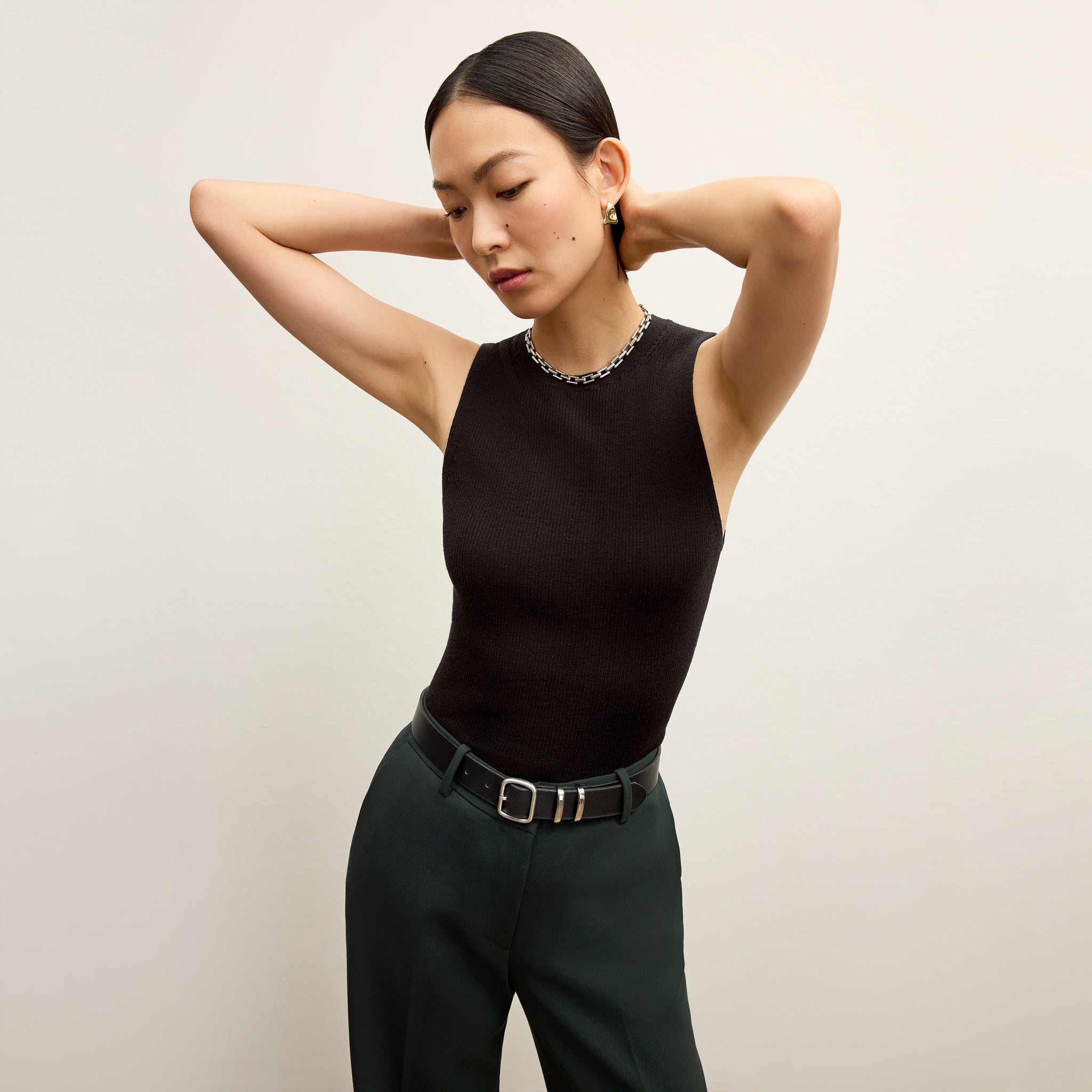 front image of a woman wearing the trina top in black 