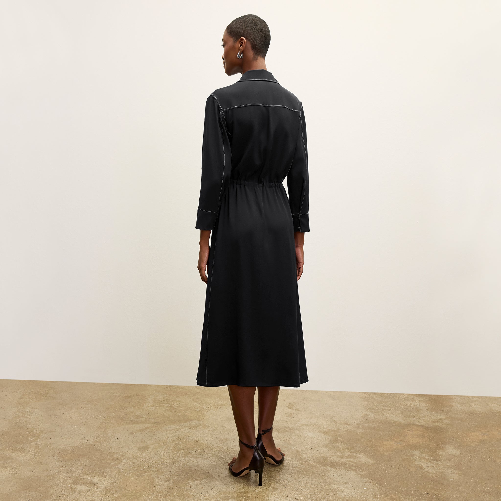 back image of a woman wearing the pepper dress in black