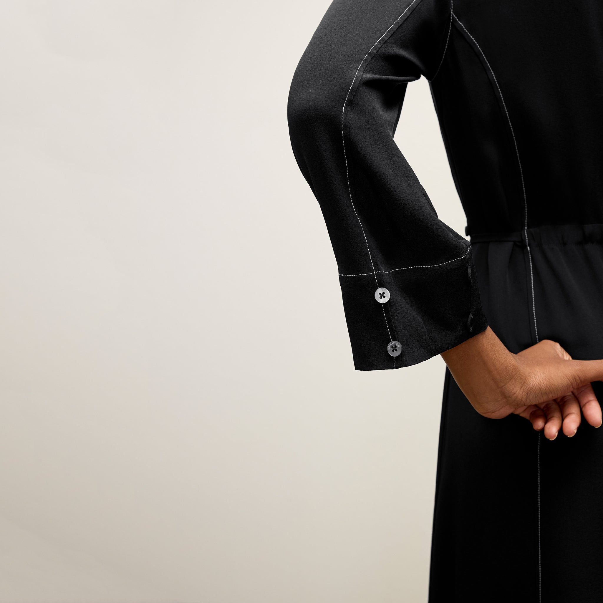 detail image of a woman wearing the pepper dress in black