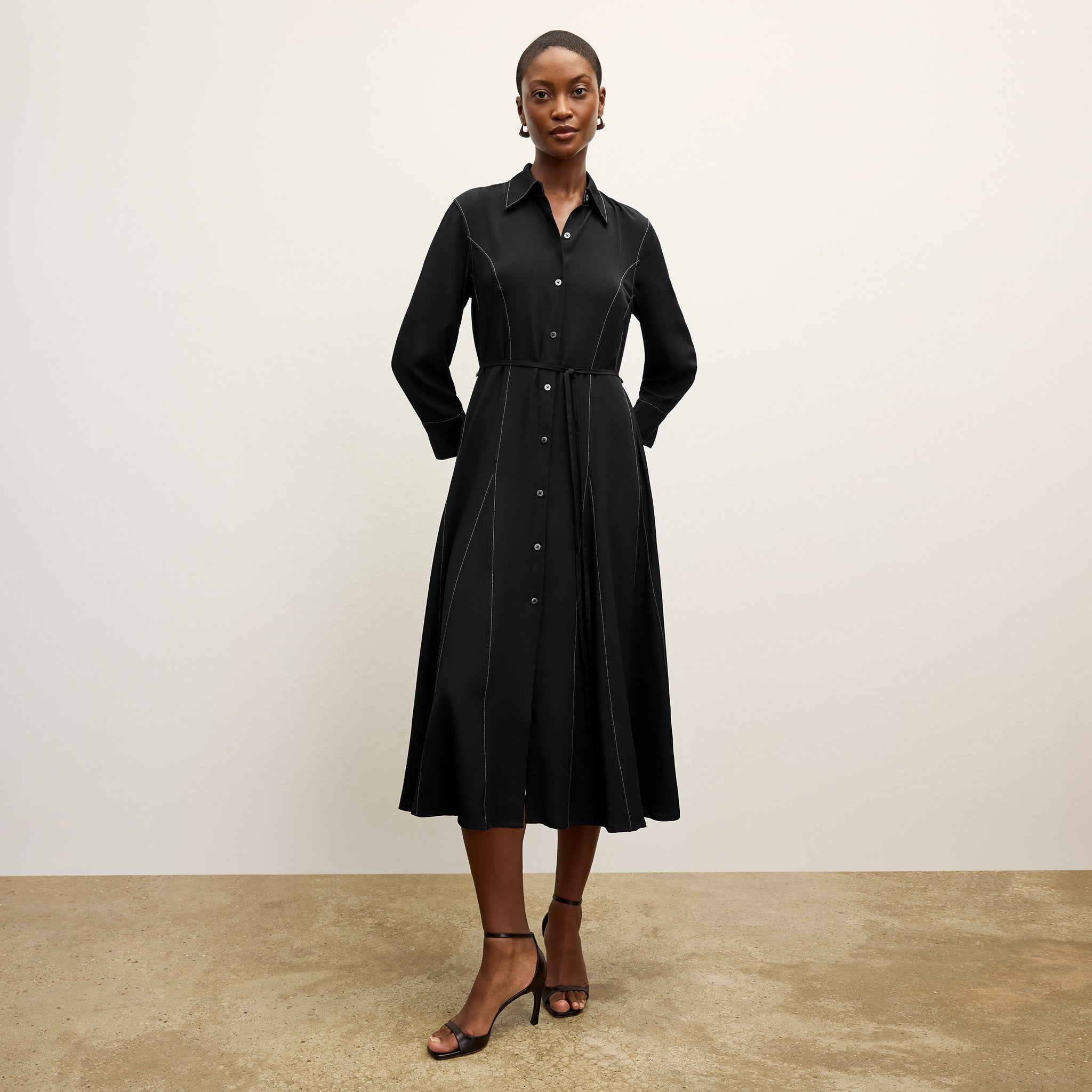 front image of a woman wearing the pepper dress in black 