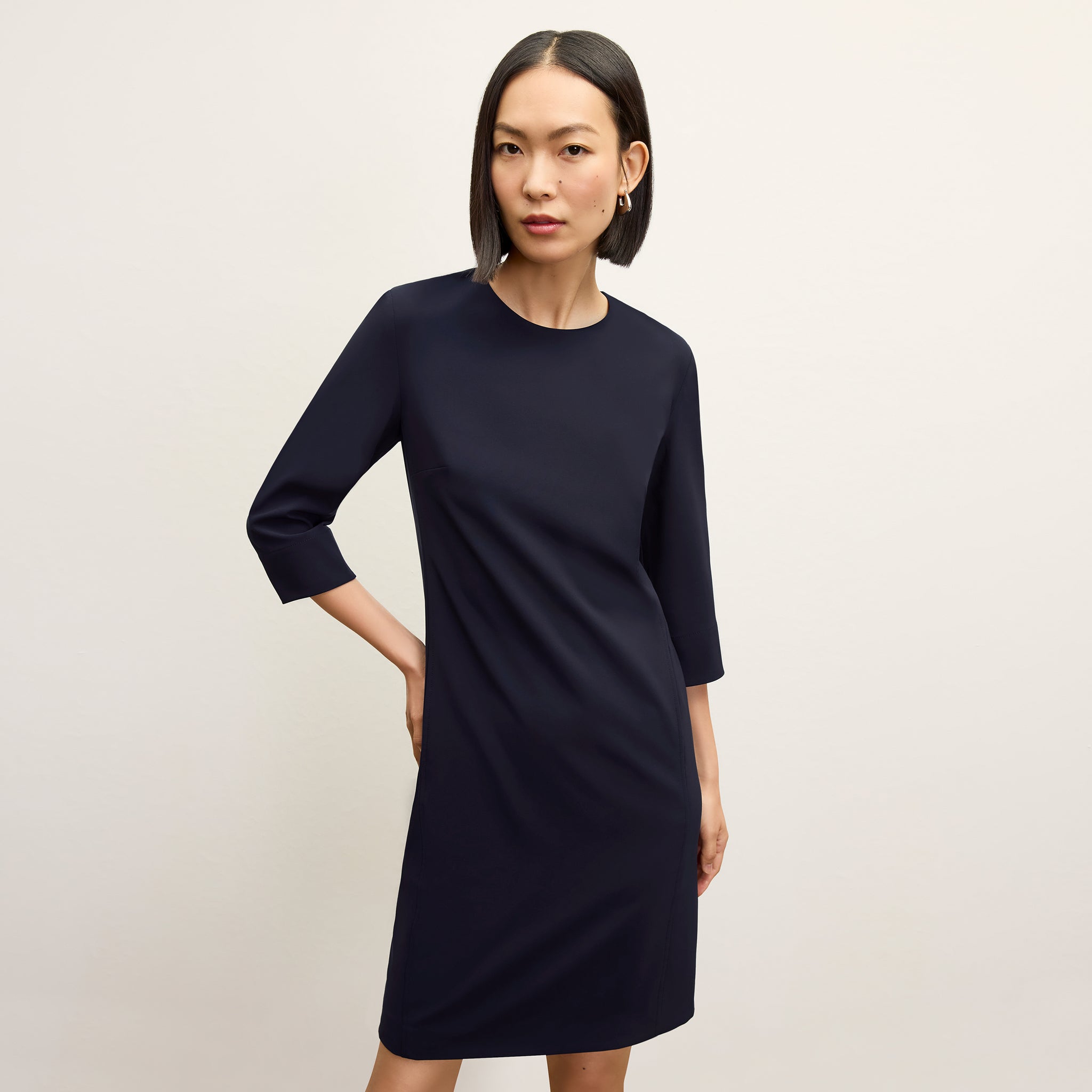 front image of a woman wearing the lancia dress in dark navy 