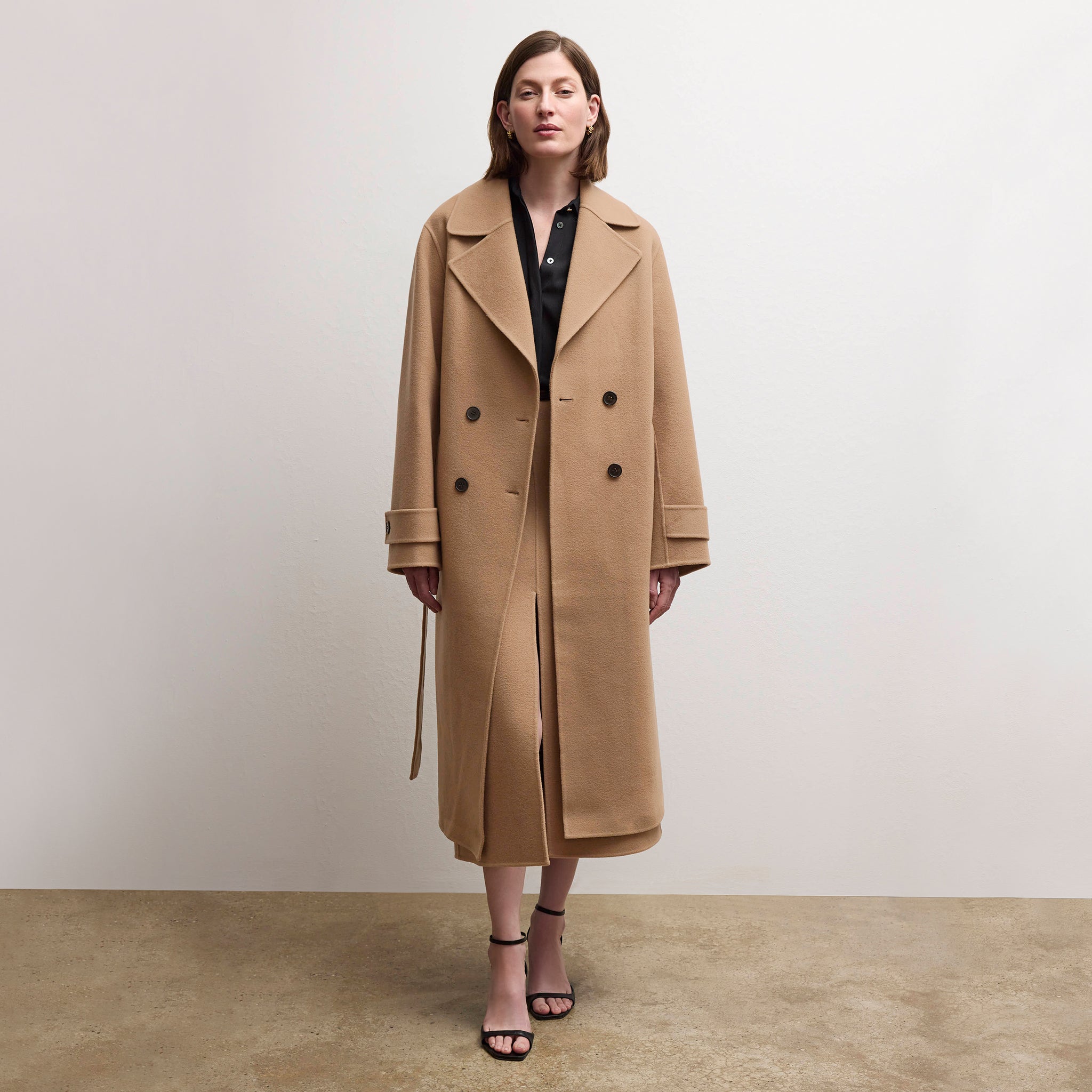 front image of a woman wearing the viola coat in camel 