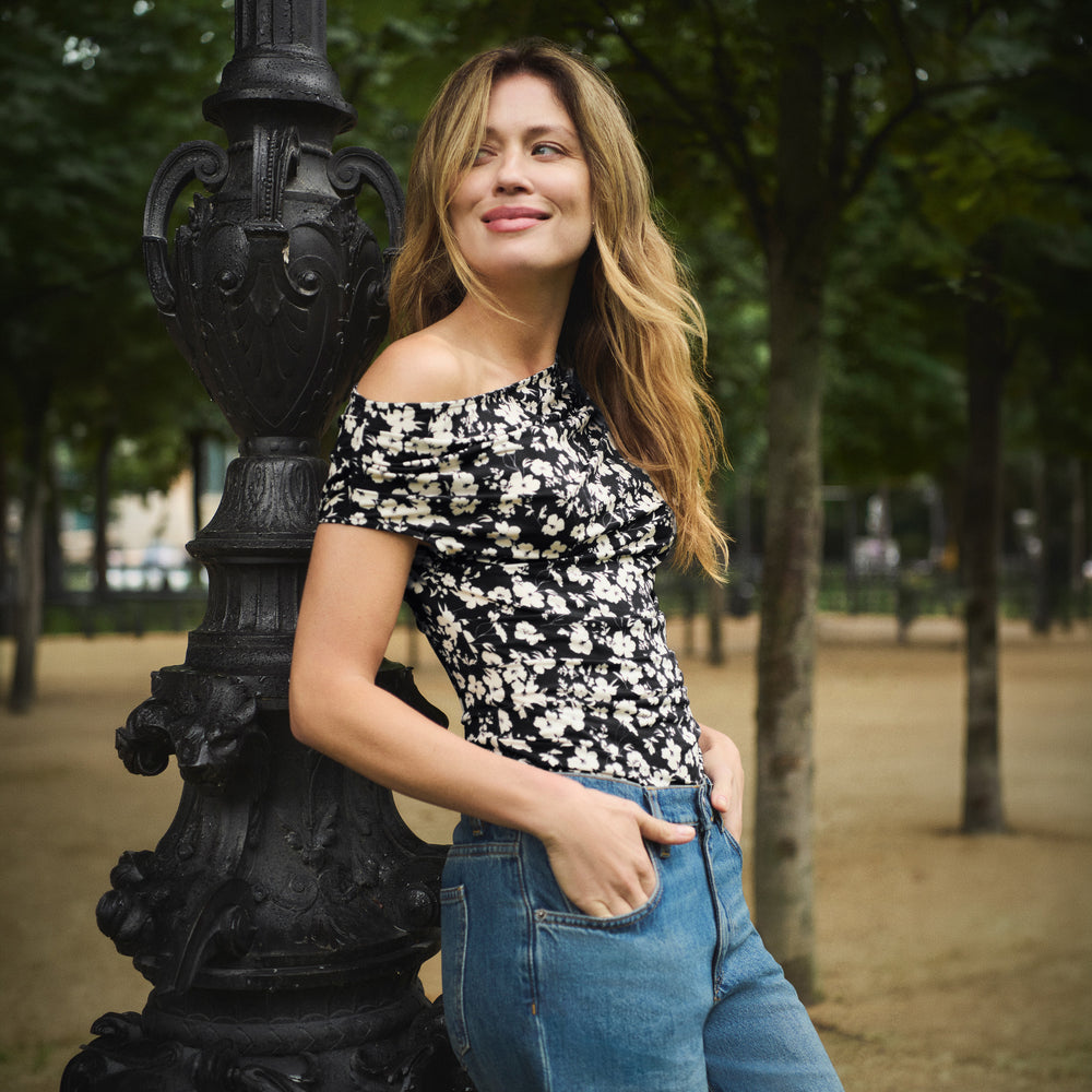 Woman wearing a floral off the shoulder top and jeans