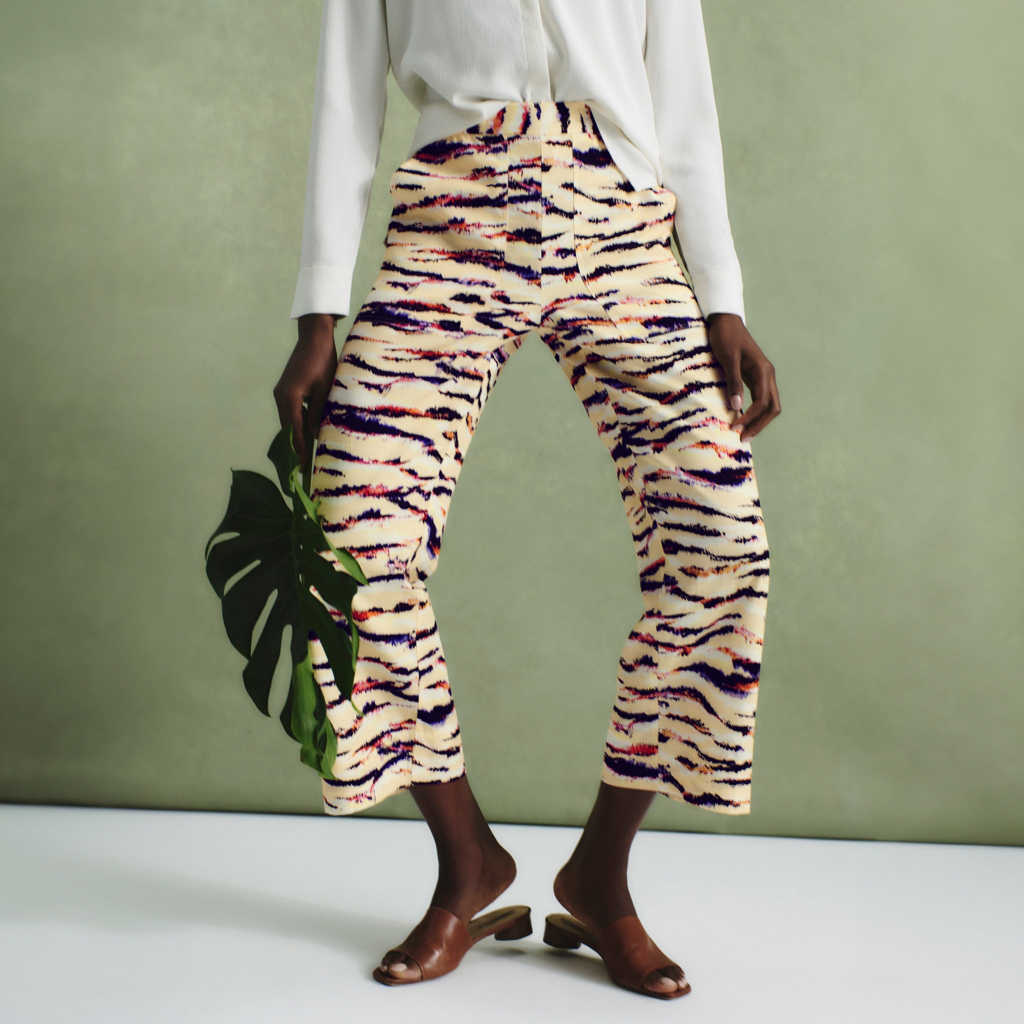 front image of a woman wearing the madelyn pant in savannah print