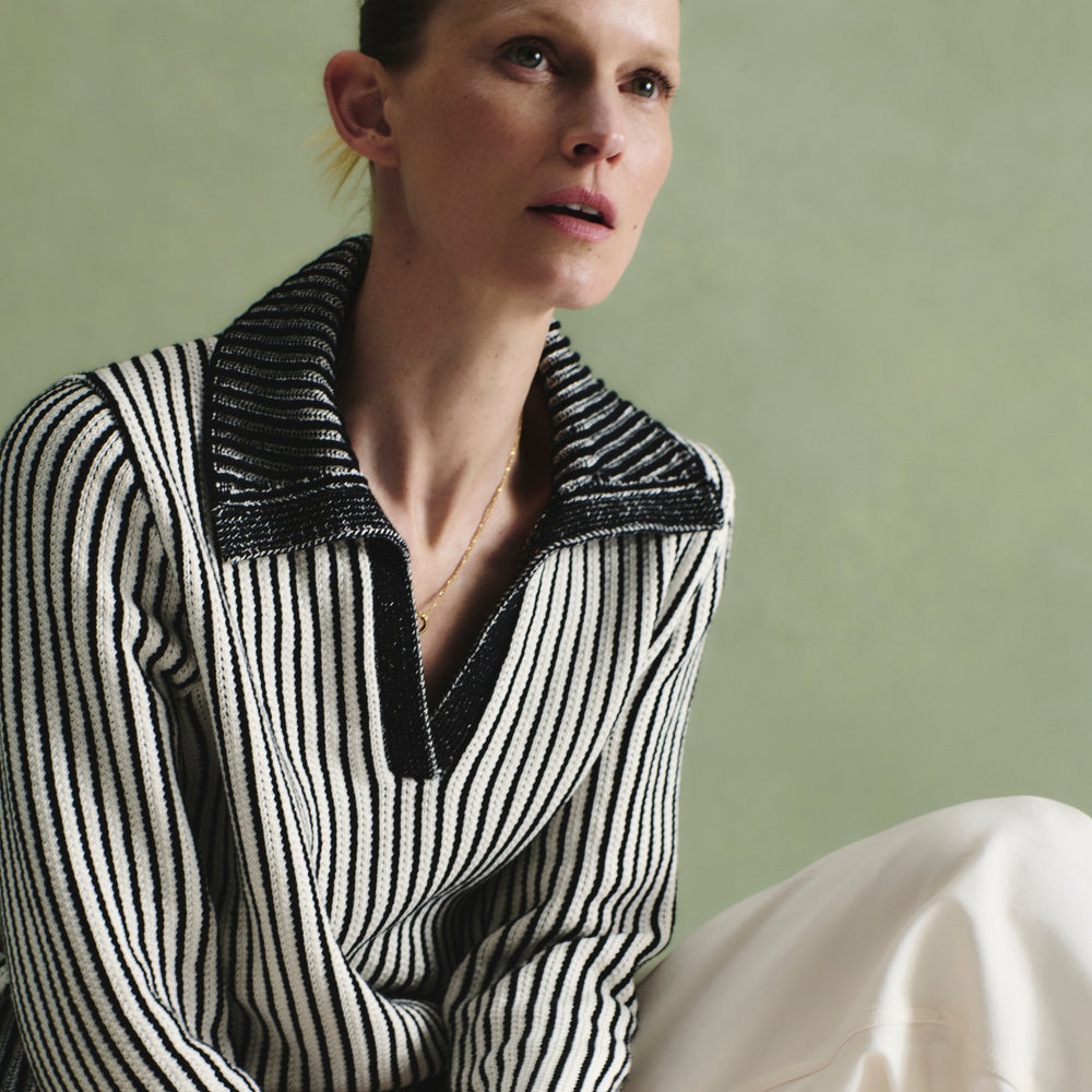 front image of a woman wearing the maja sweater in black/ivory