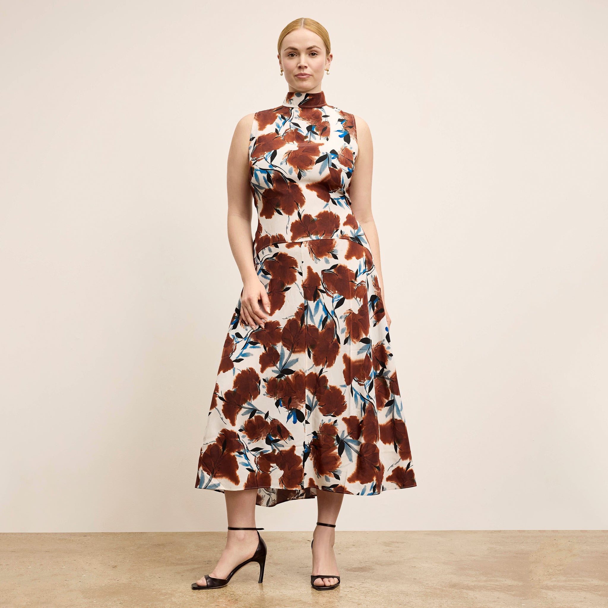 Woman wearing a floral dress with a neutral background