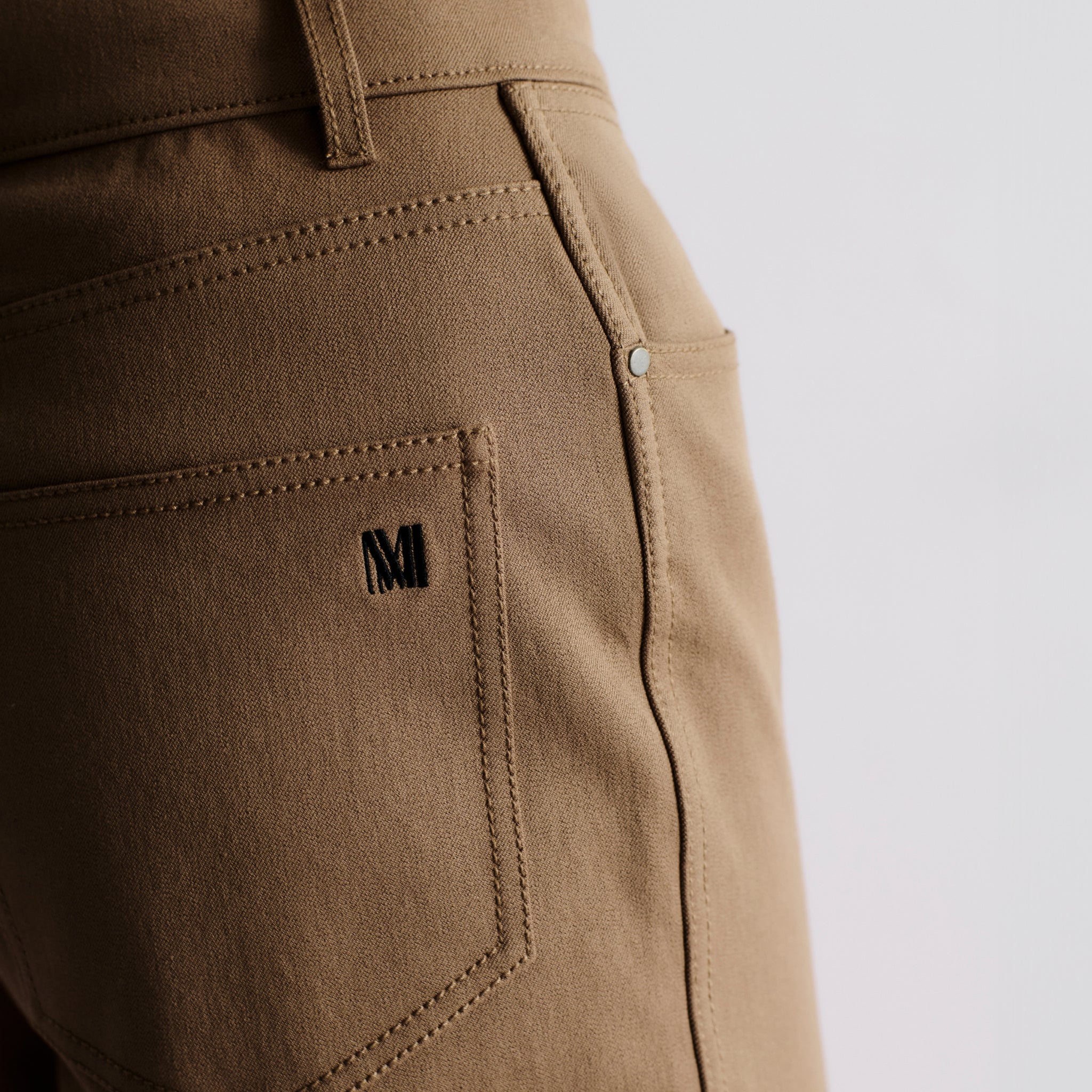 detail image of the M.M. LaFleur Logo on the back pocket of the jean