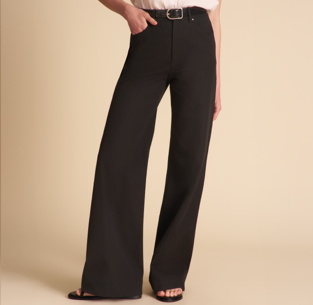 Black wide-leg pants worn by a person on a beige background