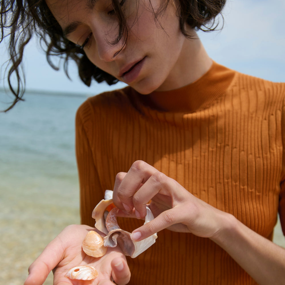 front image of a woman wearing the montean top in caramel