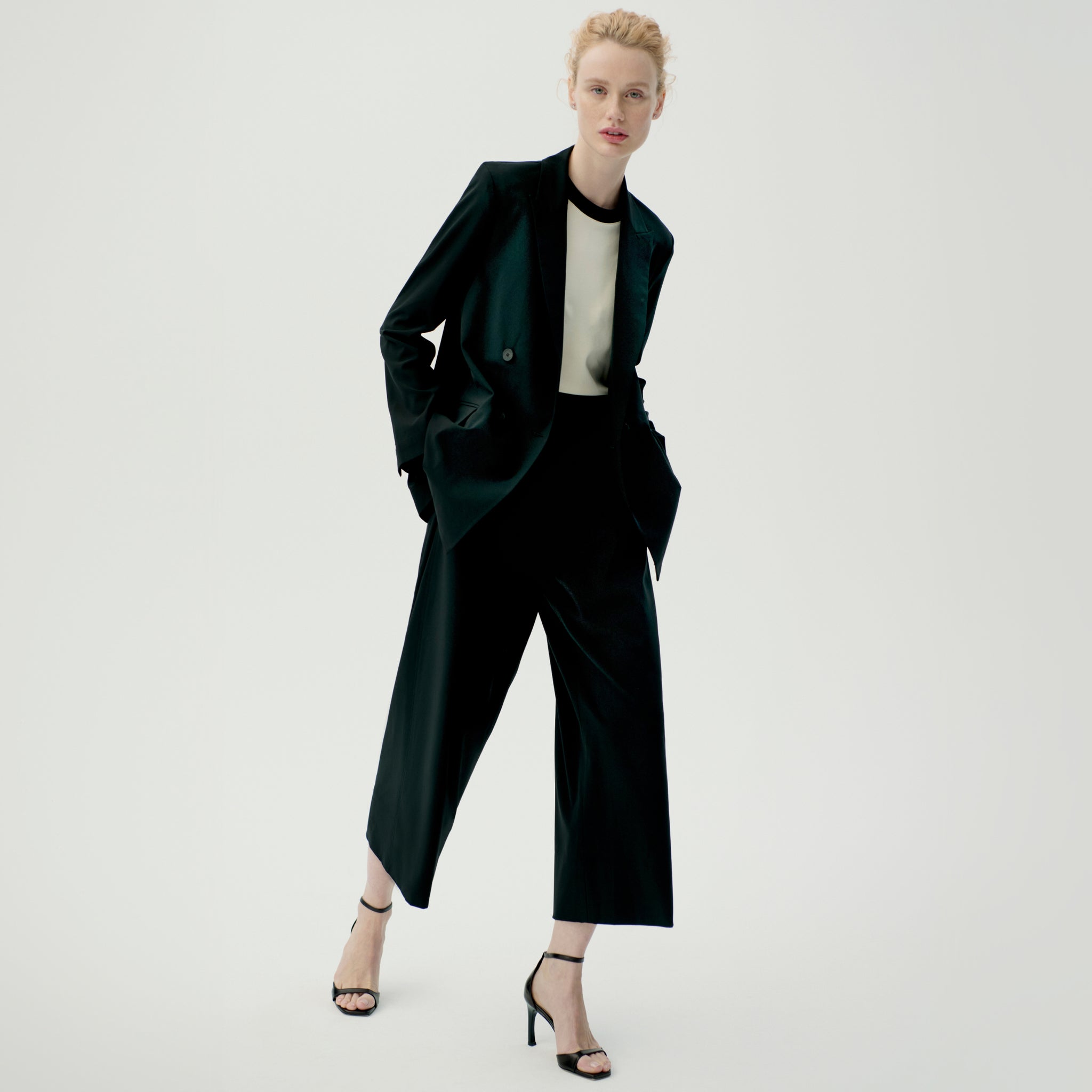 Front image of a woman wearing the elena pant in black