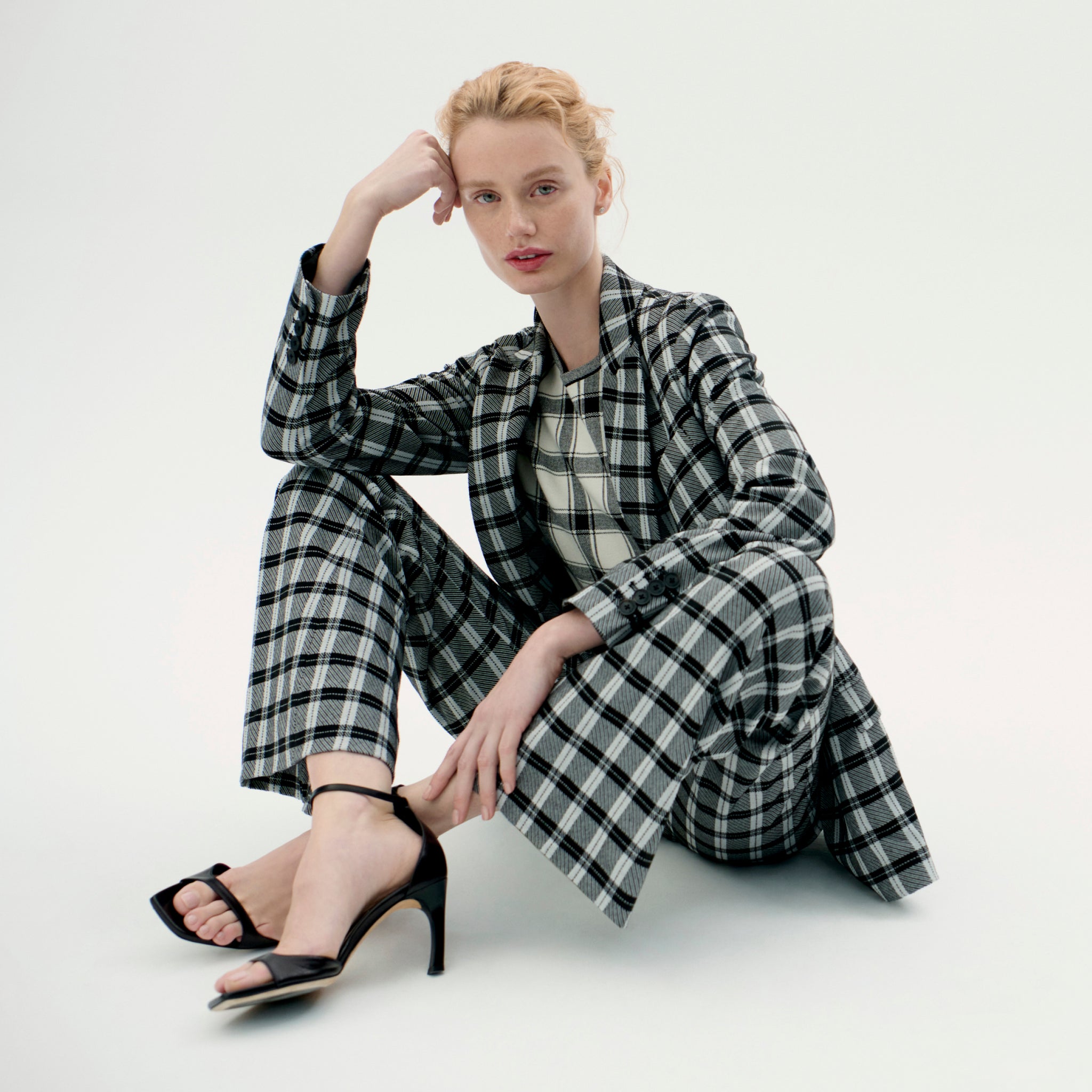 image of a woman wearing the choe top in bold check