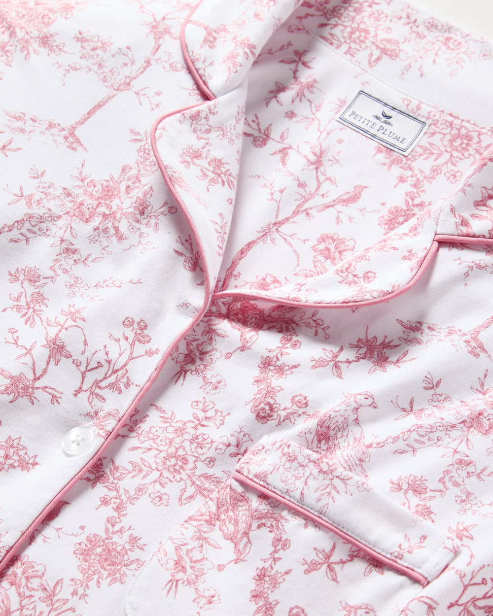 Floral patterned fabric with a brand label on a white background