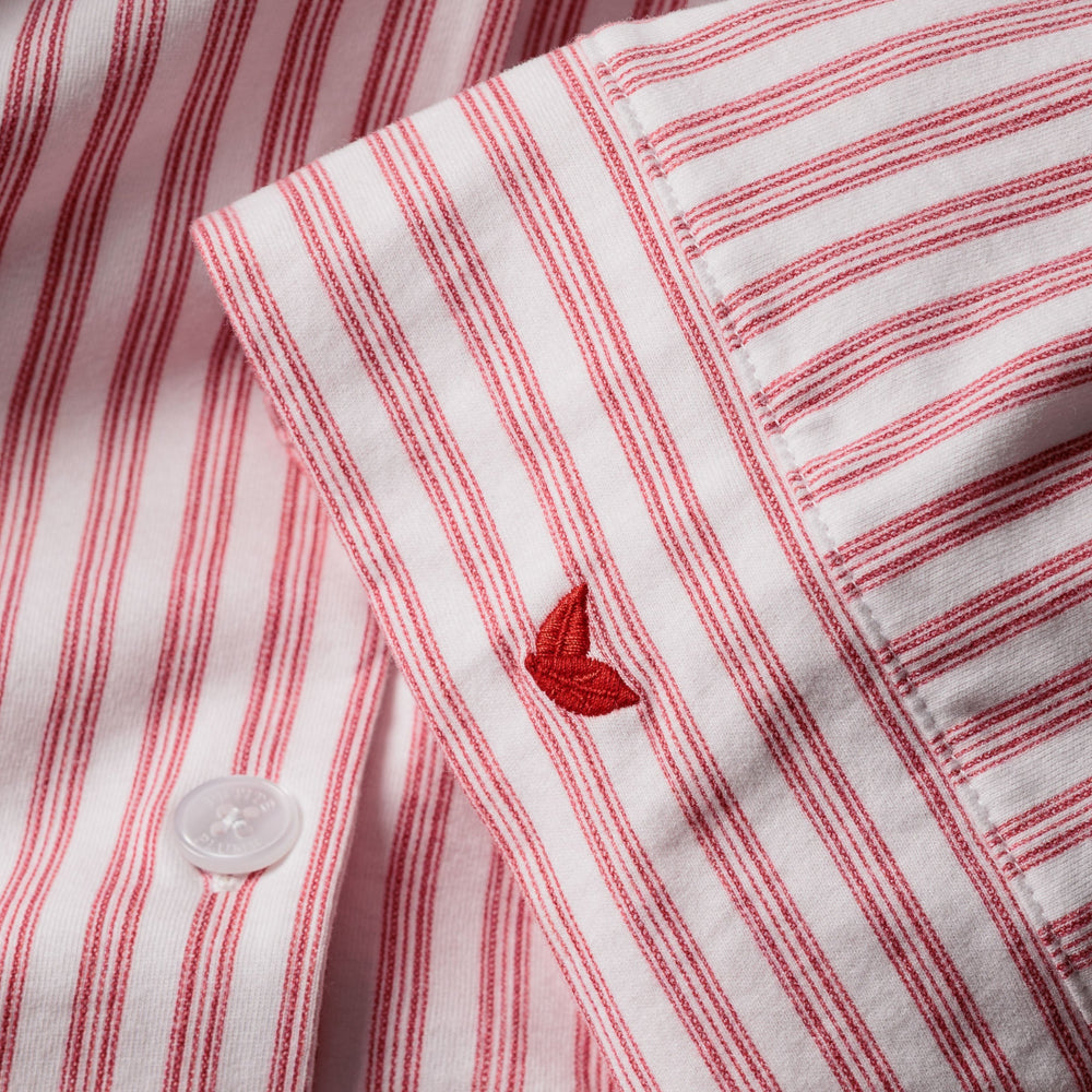 Close-up of a red and white striped fabric with a small red emblem.