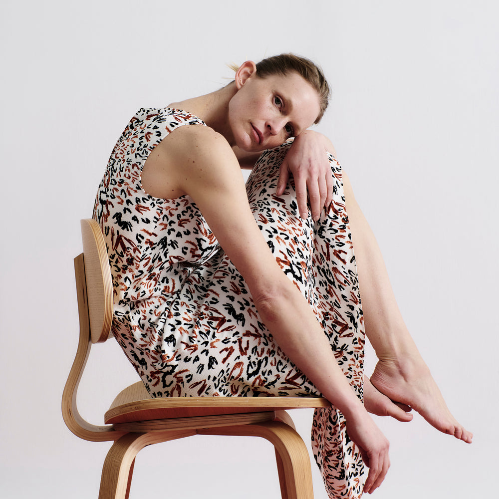side image of a woman wearing the priya dress in leopard sketch