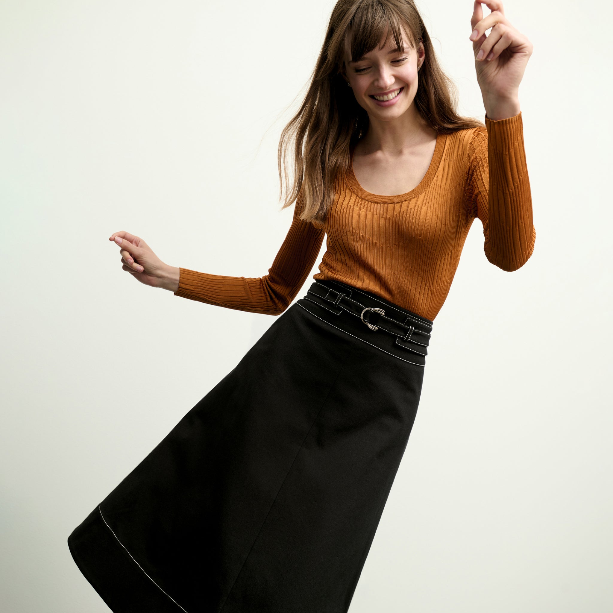 front image of a woman wearing the rae top in caramel
