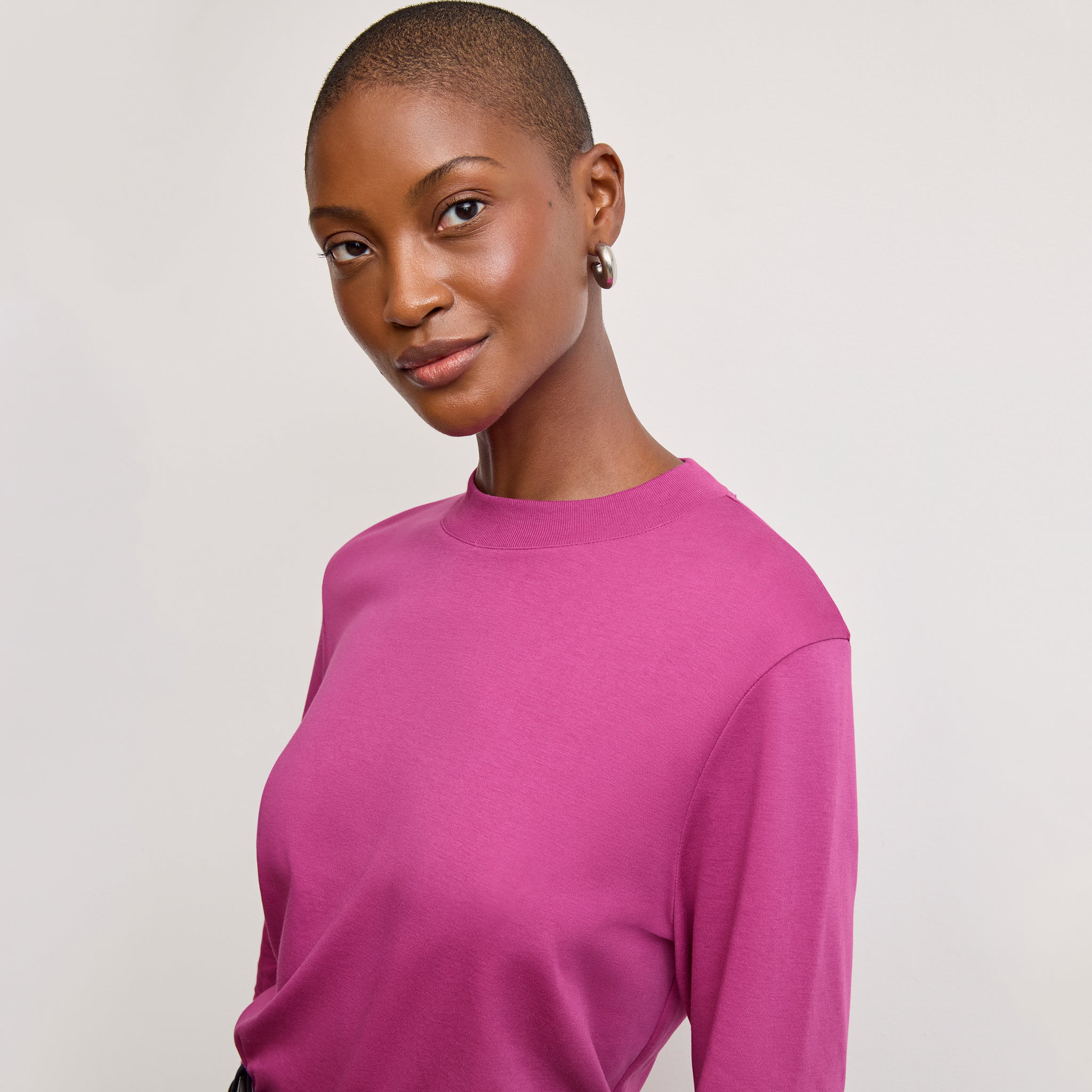 front image of a woman wearing the raquel t-shirt in pink berry 