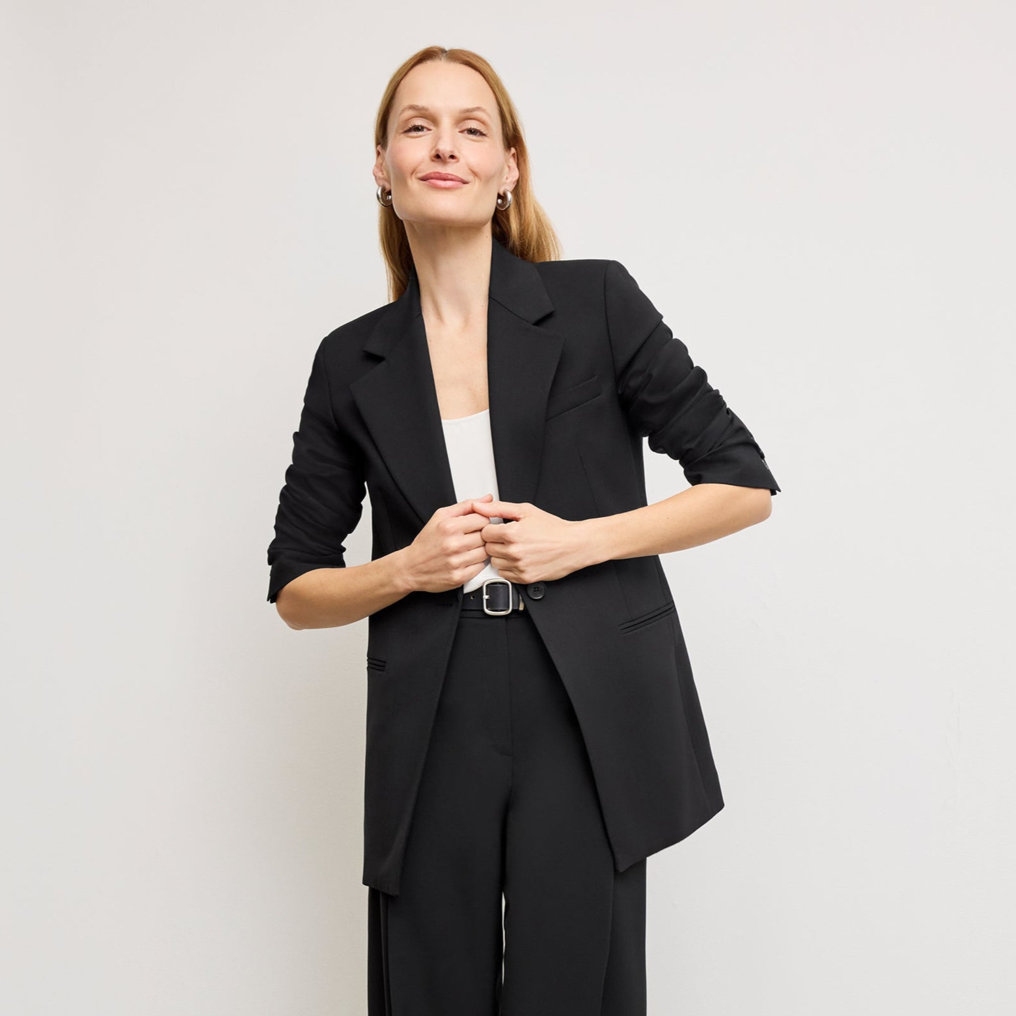front image of a woman wearing the rossi blazer in black 