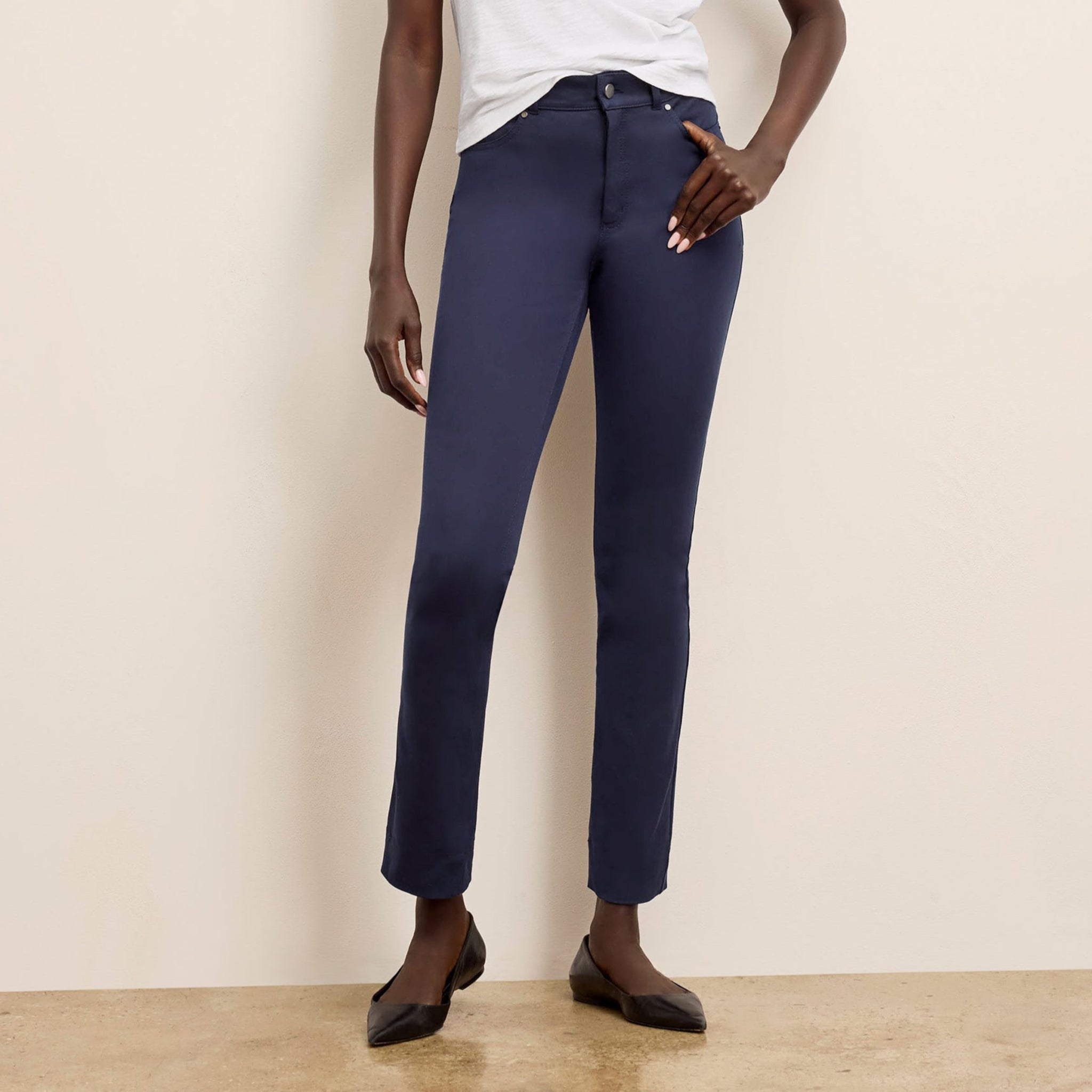 Front image of a woman wearing the roma pants in dark navy 