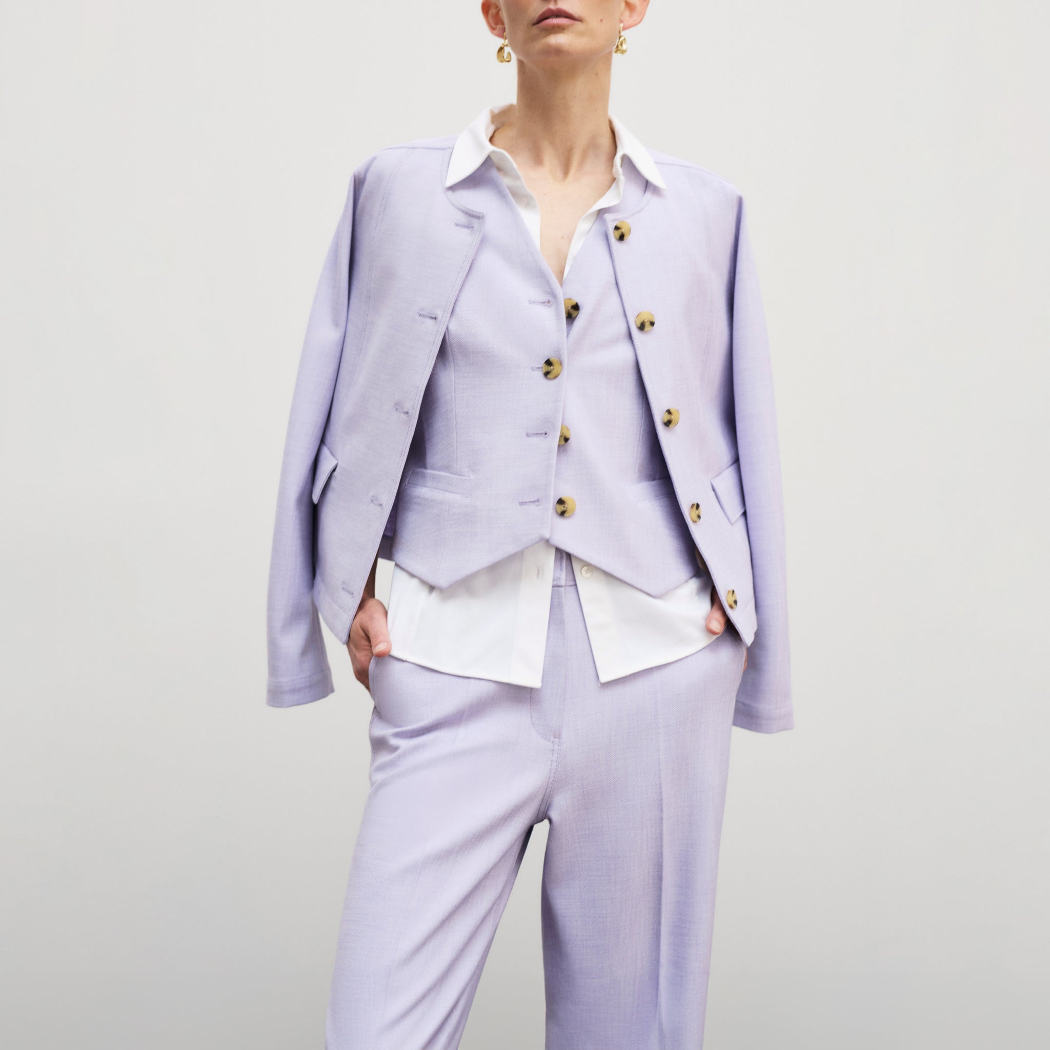 front image of a woman wearing the lani pant in lilac/ivory