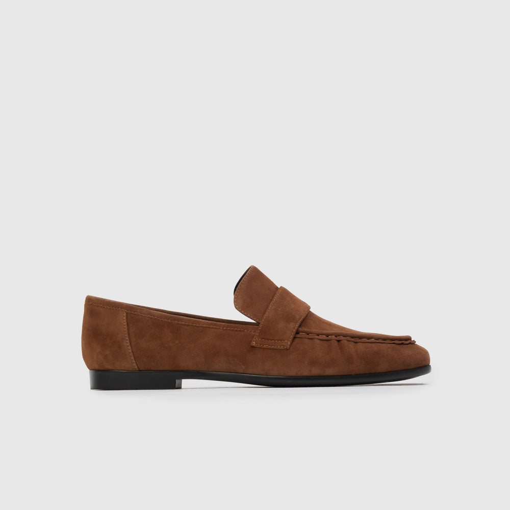 Brown loafer shoe on a light gray background