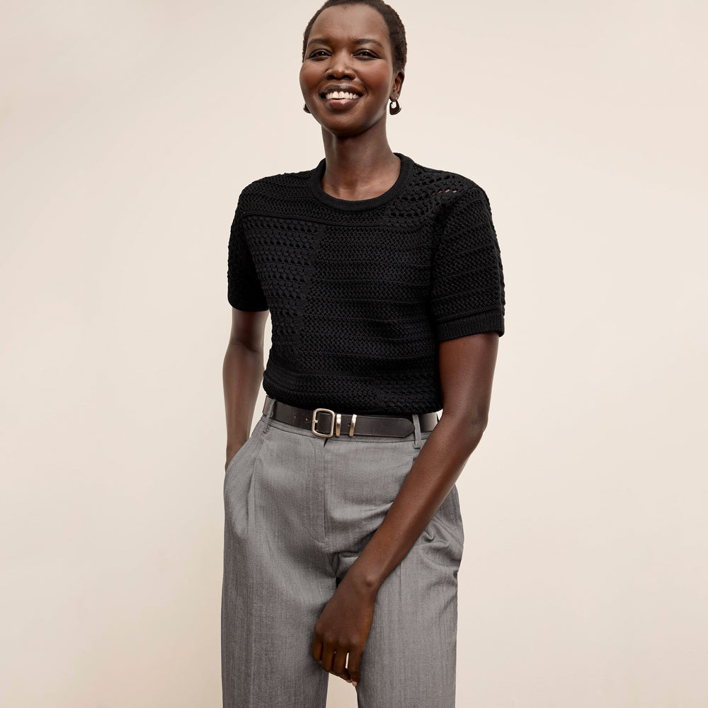 Front image of a woman wearing the Sina top in black