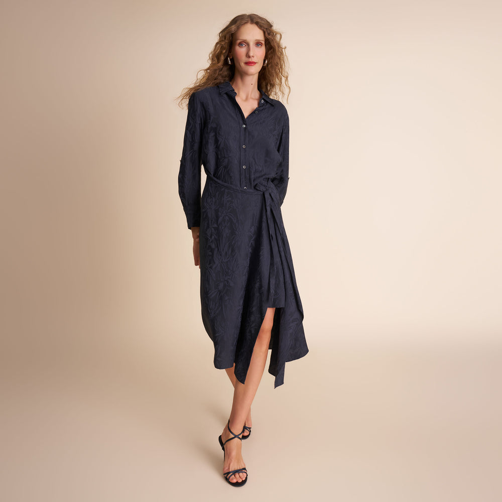 Woman wearing a navy blue dress on a beige background