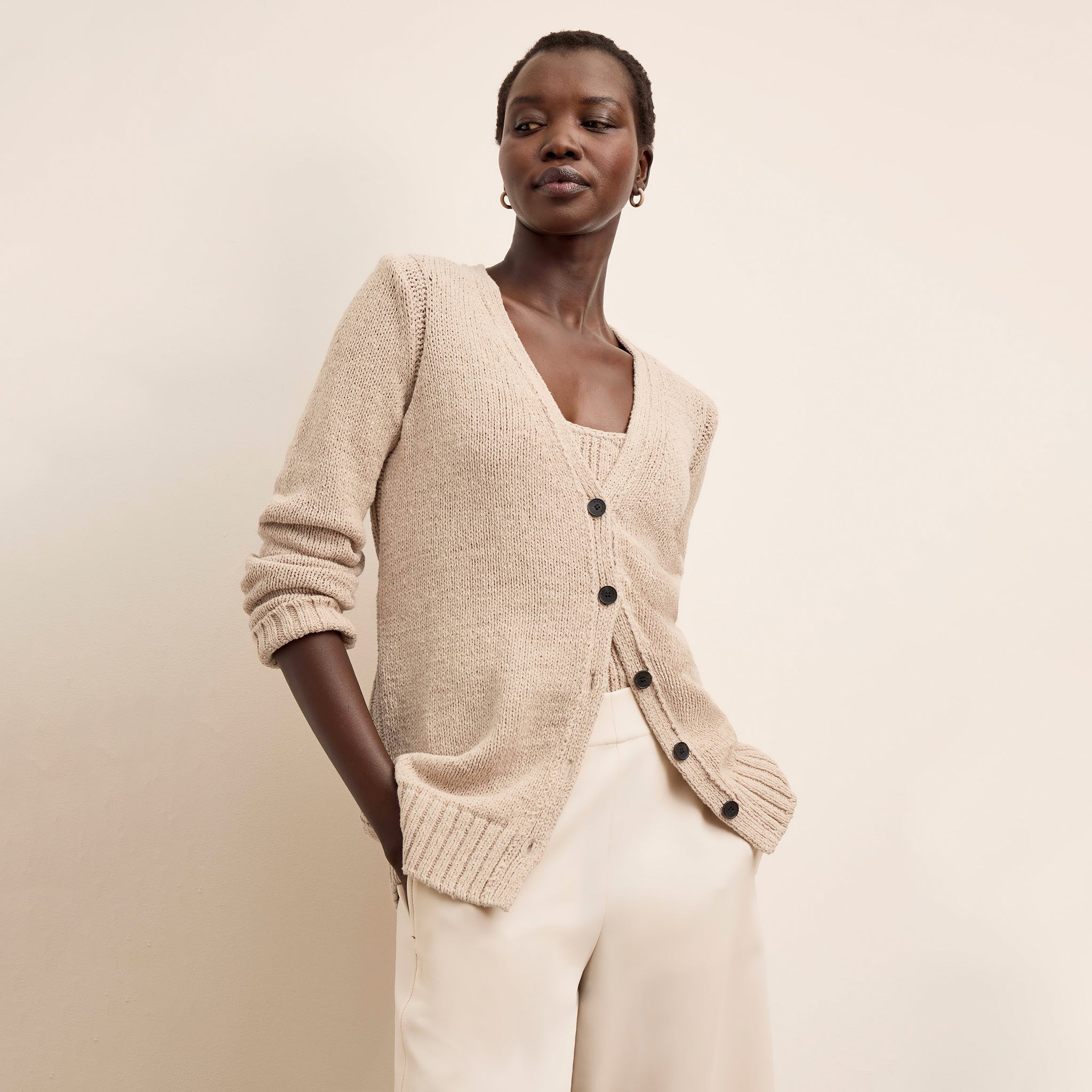Front image of a woman wearing the Tali Cardigan in Tan 