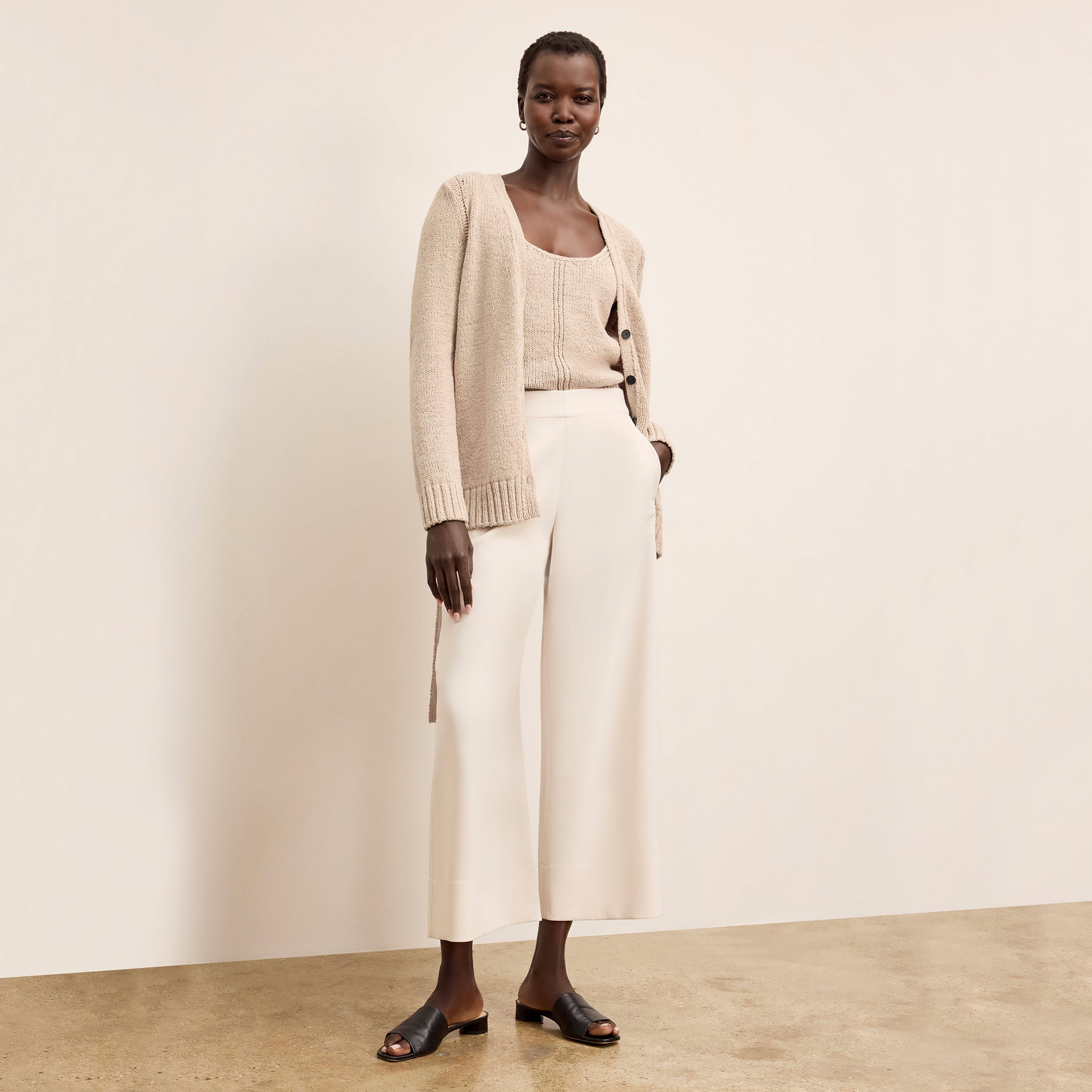 Front image of a woman wearing the Tali Cardigan in Tan