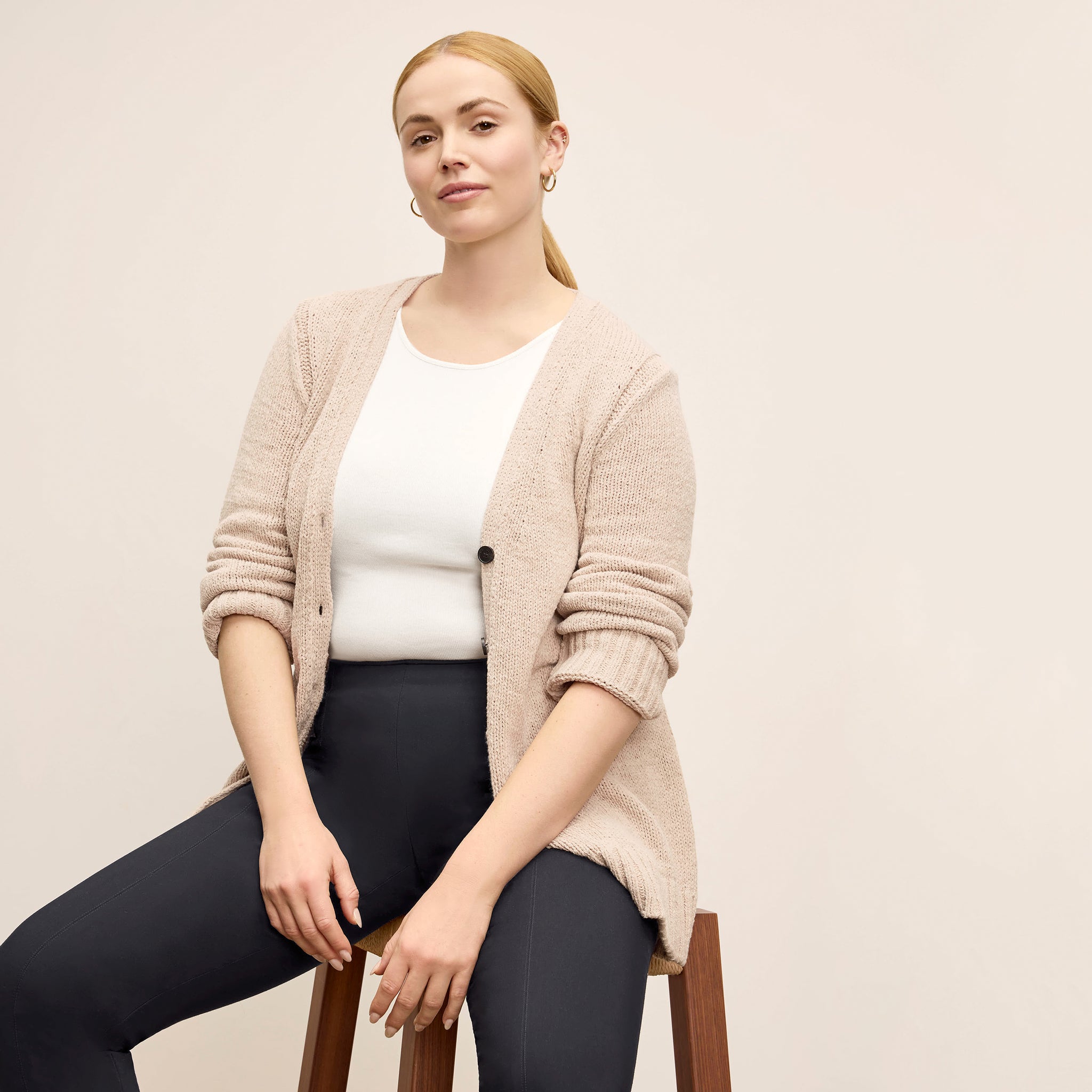 Front image of a woman wearing the Tali Cardigan in Tan