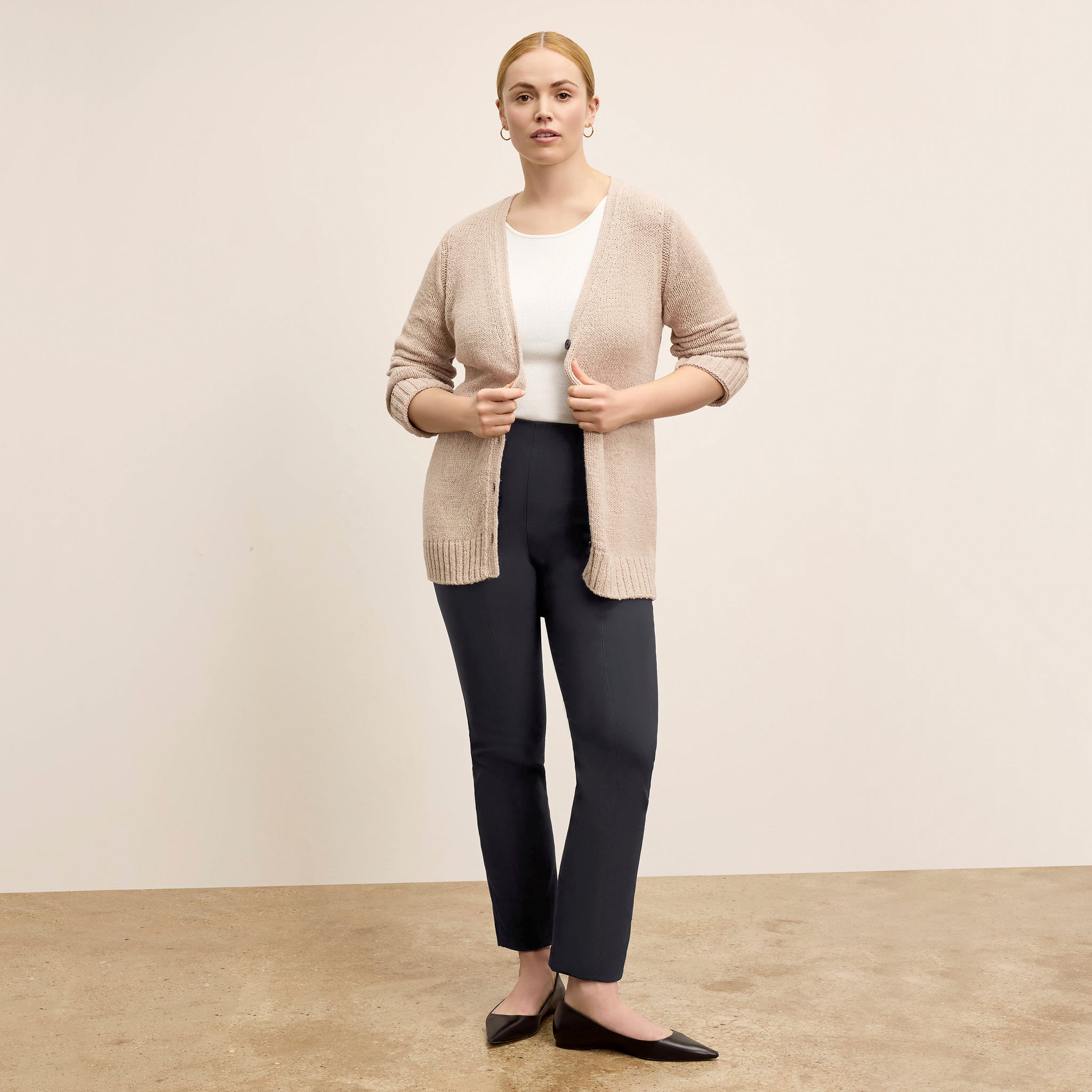 Front image of a woman wearing the Tali Cardigan in Tan