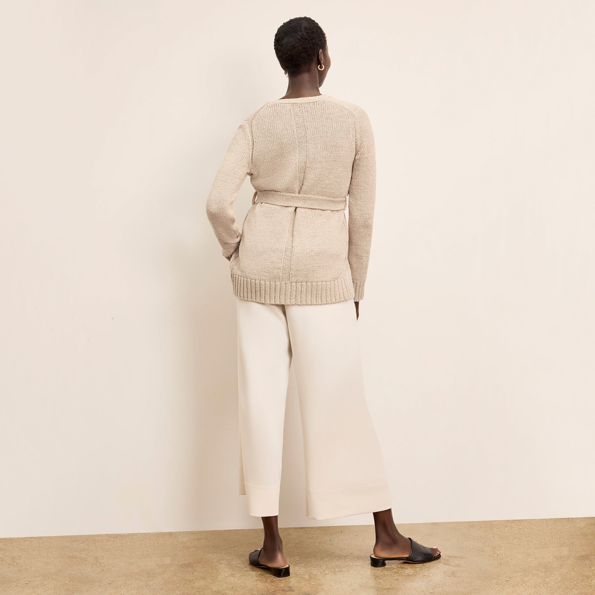 Back image of a woman wearing the Tali Cardigan in Tan