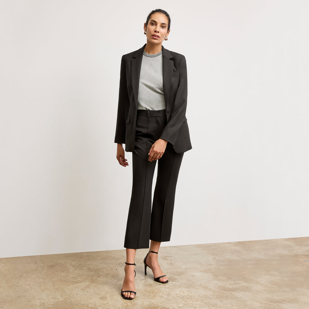 Front image of a woman wearing the becca top in light gray/ivory