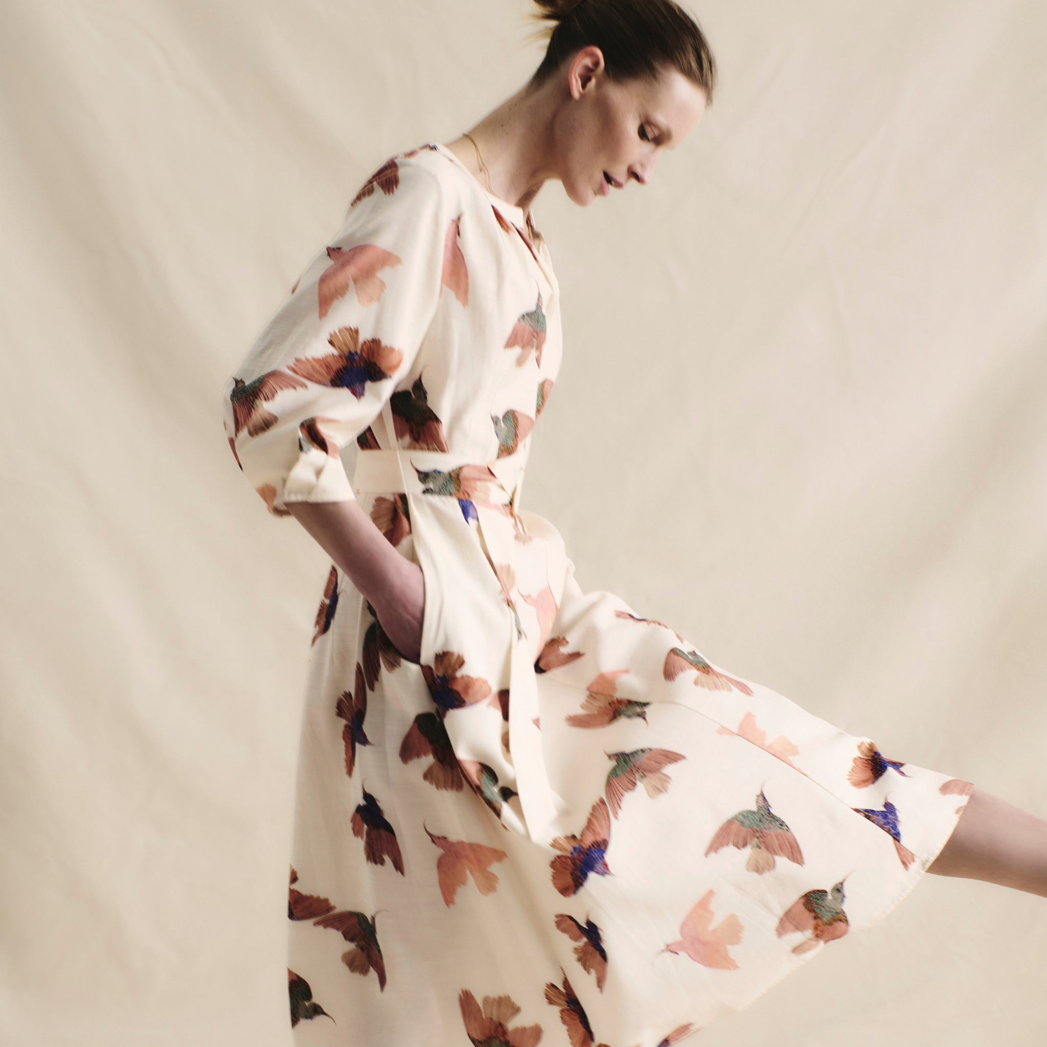 front image of a woman wearing the tessie dress in hummingbird print