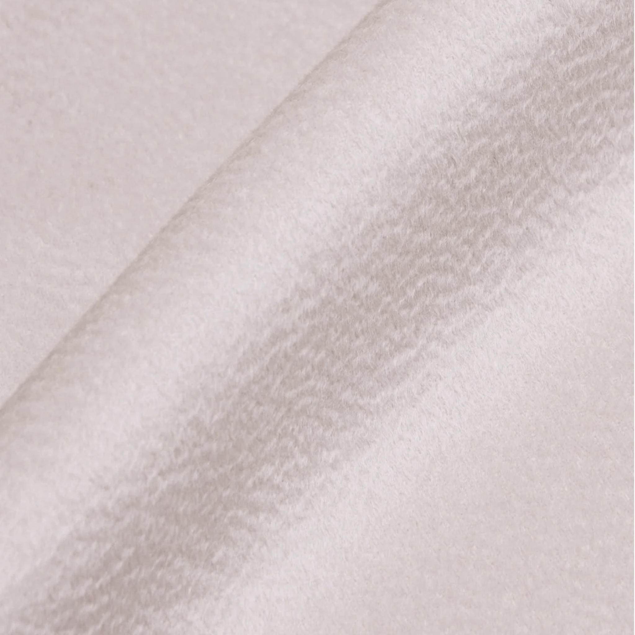 Close-up of a textured white fabric with diagonal lines