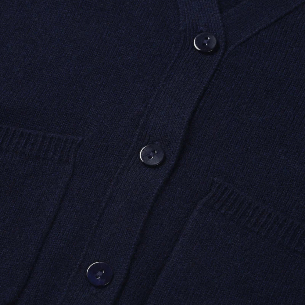 Close-up of a navy blue cardigan with button details