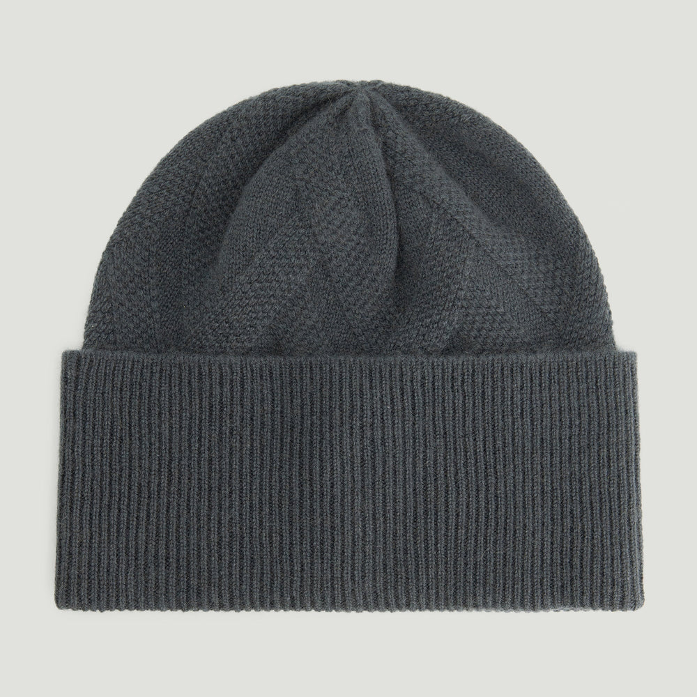Dark gray knit beanie on a light gray background
