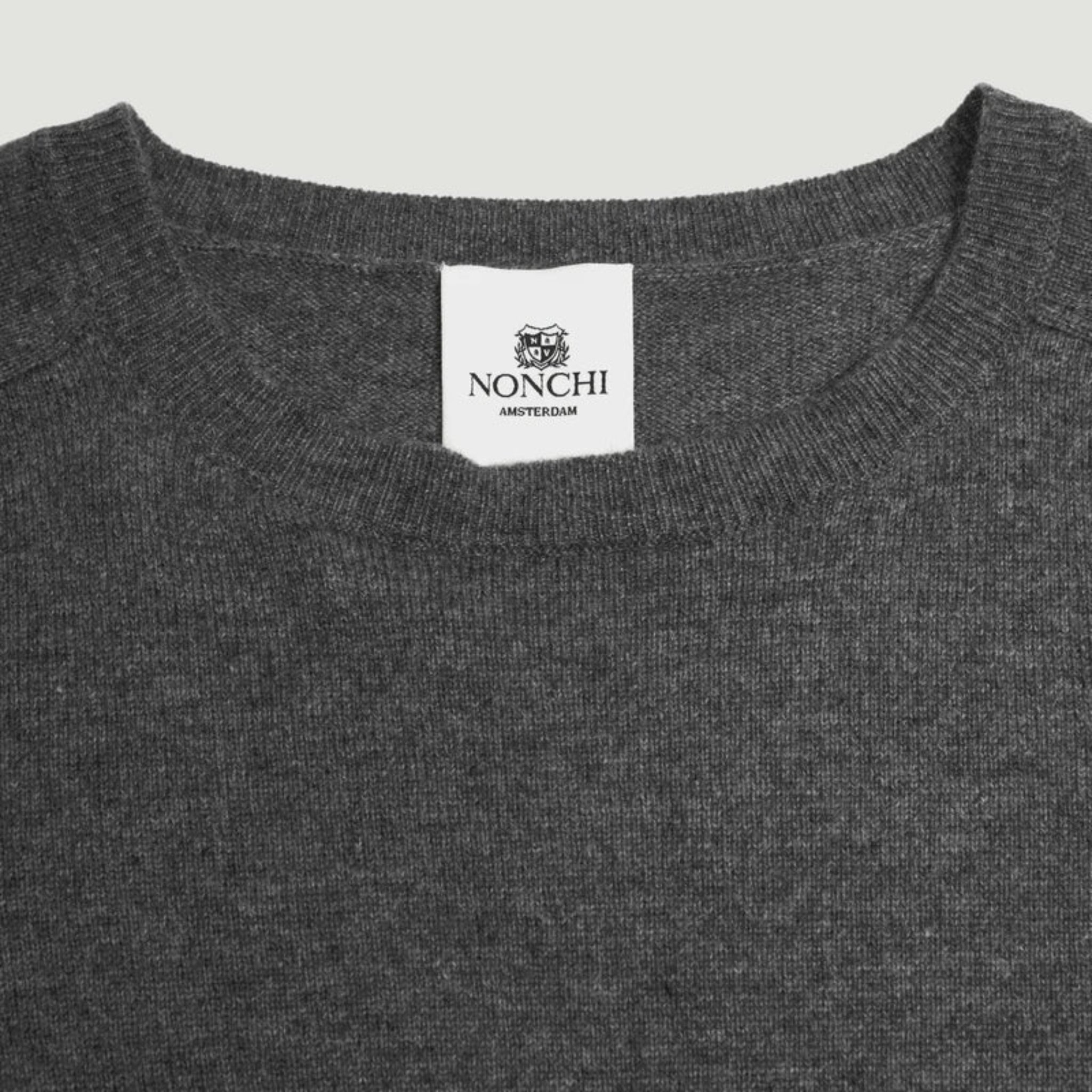 Gray sweater with a Nonchi label on a light gray background