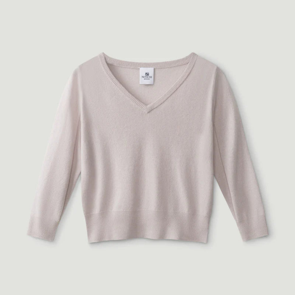 Beige long-sleeve top on a light gray background