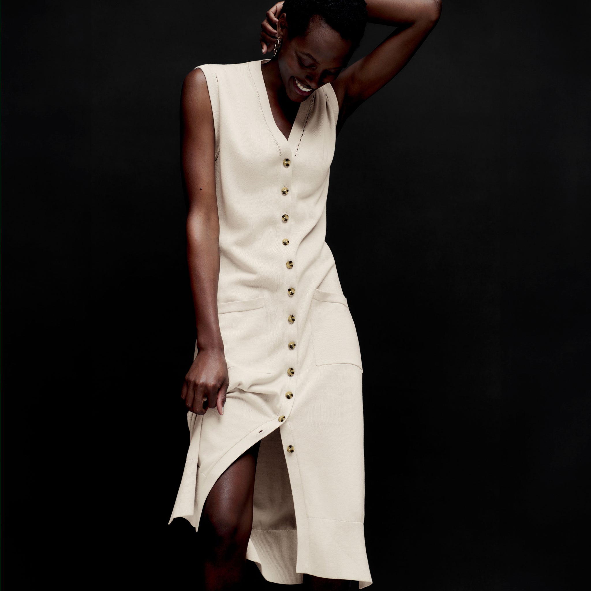 front image of a woman wearing the toula dress in ivory