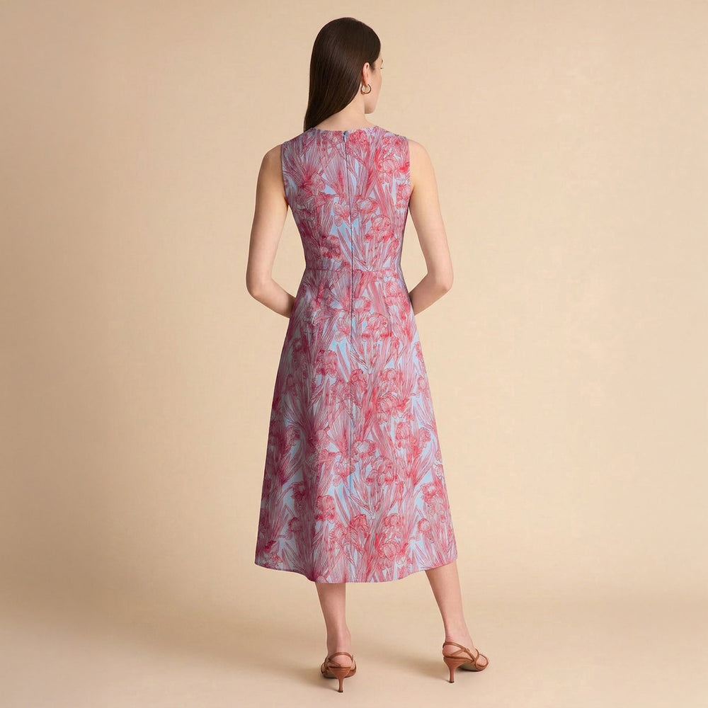 Woman wearing a sleeveless floral dress on a beige background