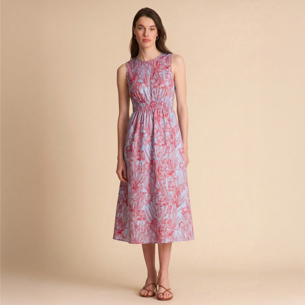 Woman wearing a sleeveless floral dress on a beige background
