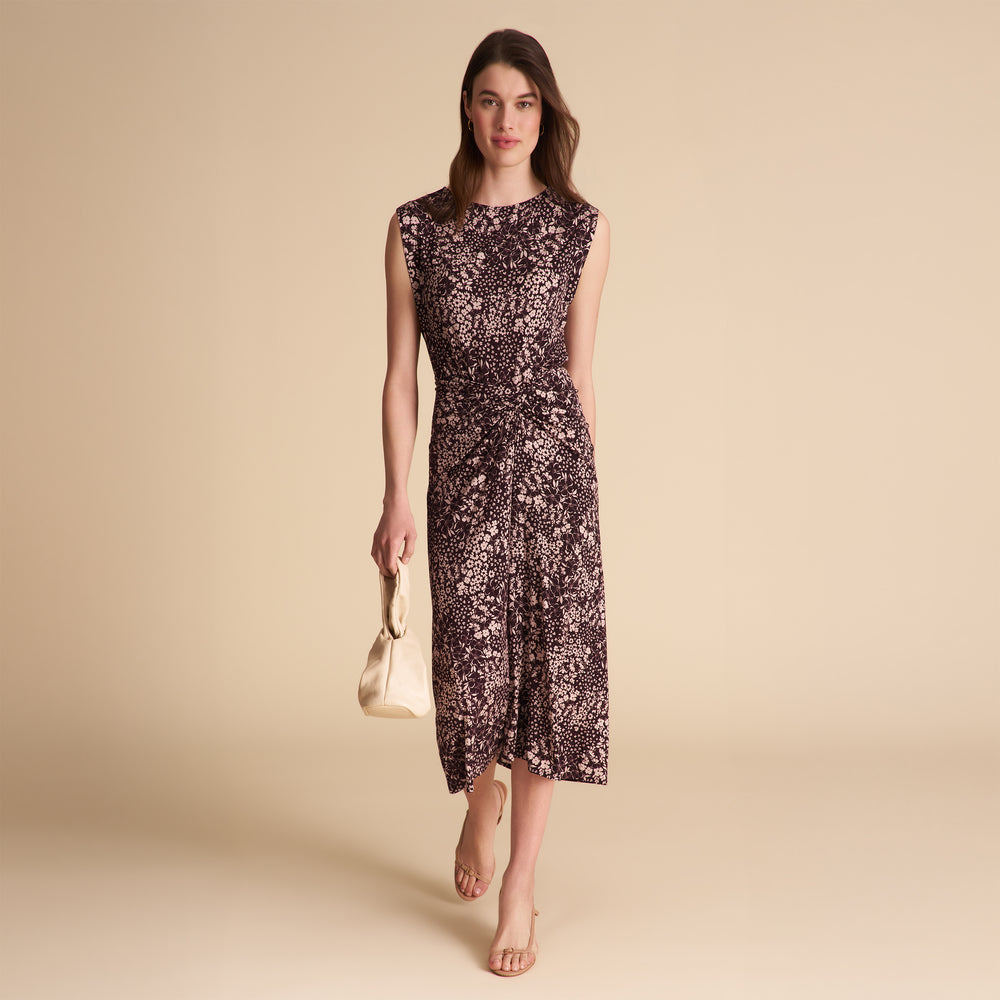 Woman wearing a floral dress on a beige background